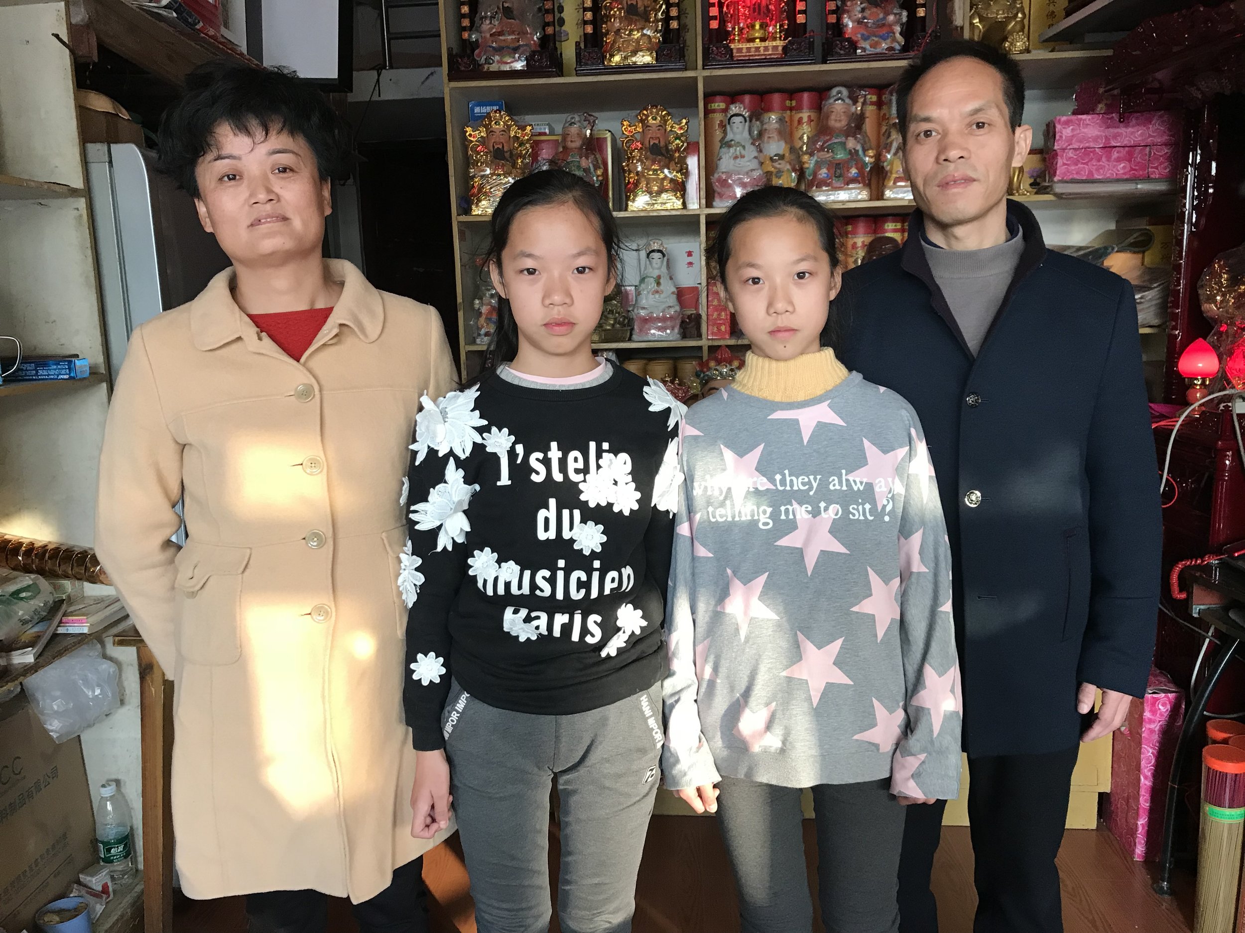  Mother, Zhu Yuan e, and father Xin Xian Shou, with their daughters inside the incense shop, 2017. 