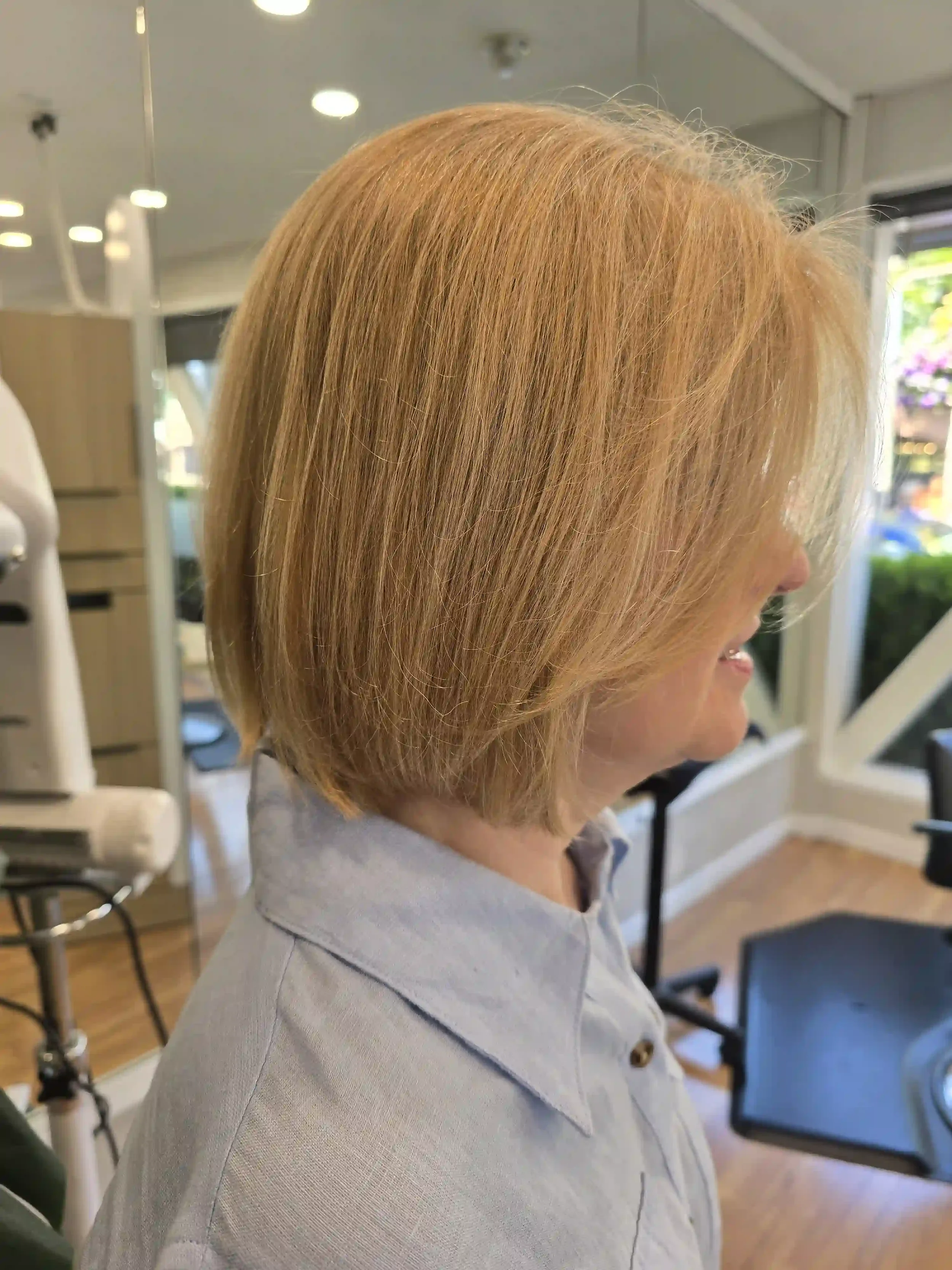 Classic blonde graduated bob with soft layering, long face-framing bangs, and a smooth, polished finish. This timeless precision haircut creates natural volume, clean lines, and effortless movement while showcasing a soft, dimensional blonde color. H