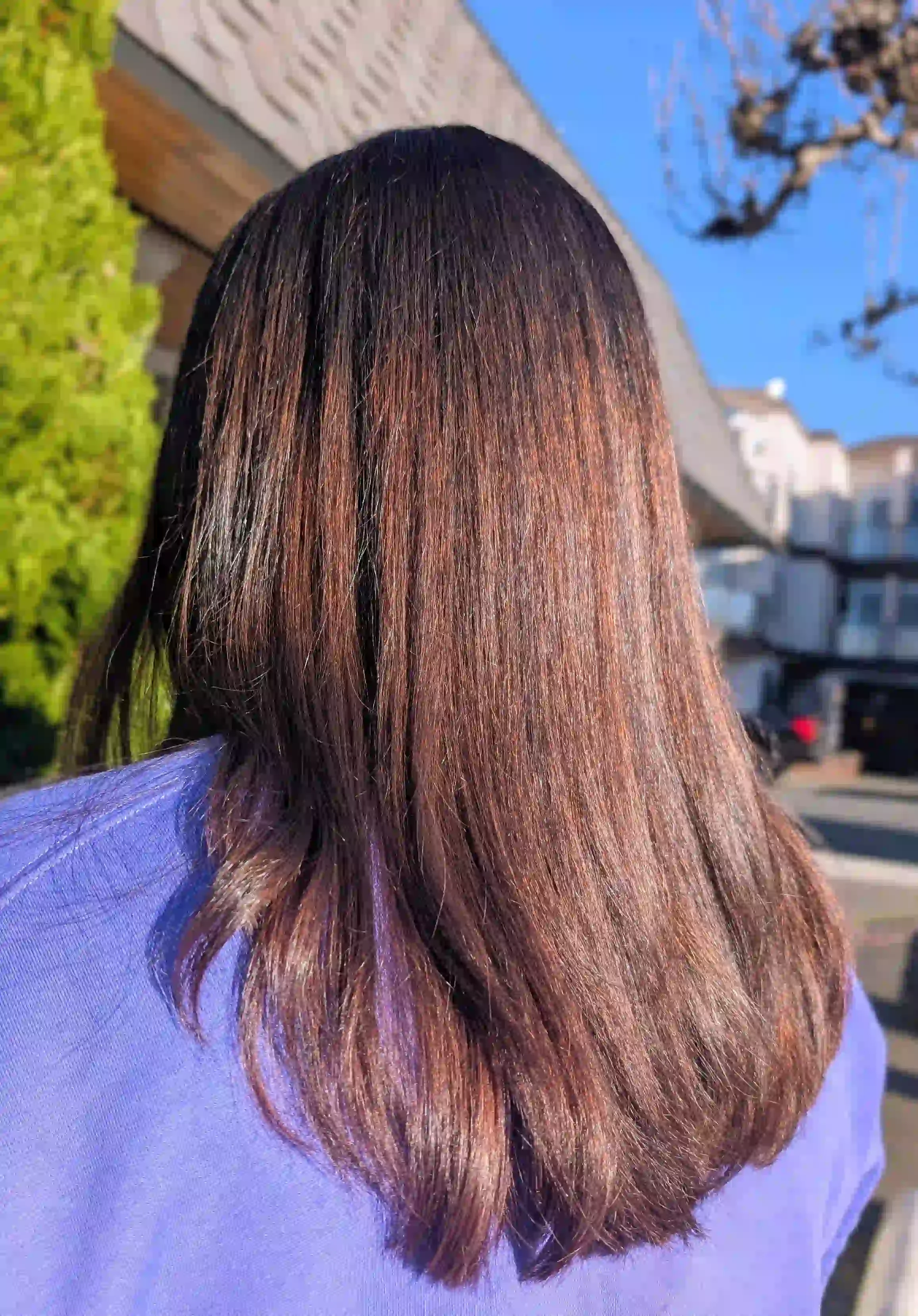 Rich auburn brunette hair color with glossy shine and soft long layers, styled by Christina at Chroma Salon Edmonds.