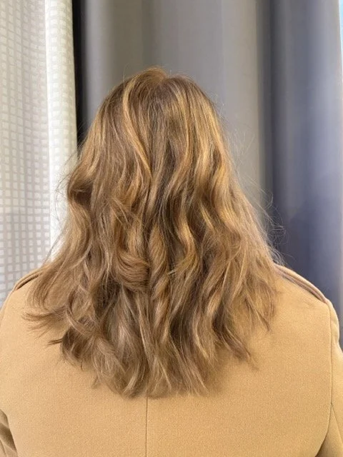 Warm caramel brunette balayage with soft, beachy waves and natural dimension, styled at Chroma Salon Seattle for a healthy, glossy finish.