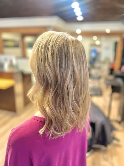 Soft blonde balayage with natural waves and subtle dimension, styled at Chroma Salon Seattle for a bright, lived-in finish.
