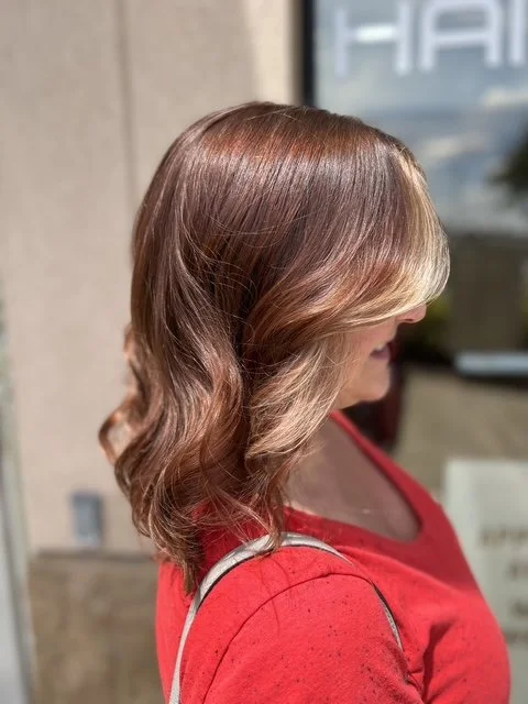Warm copper balayage with blonde face-framing highlights and soft waves, created at Chroma Salon Seattle for rich dimension and shine.