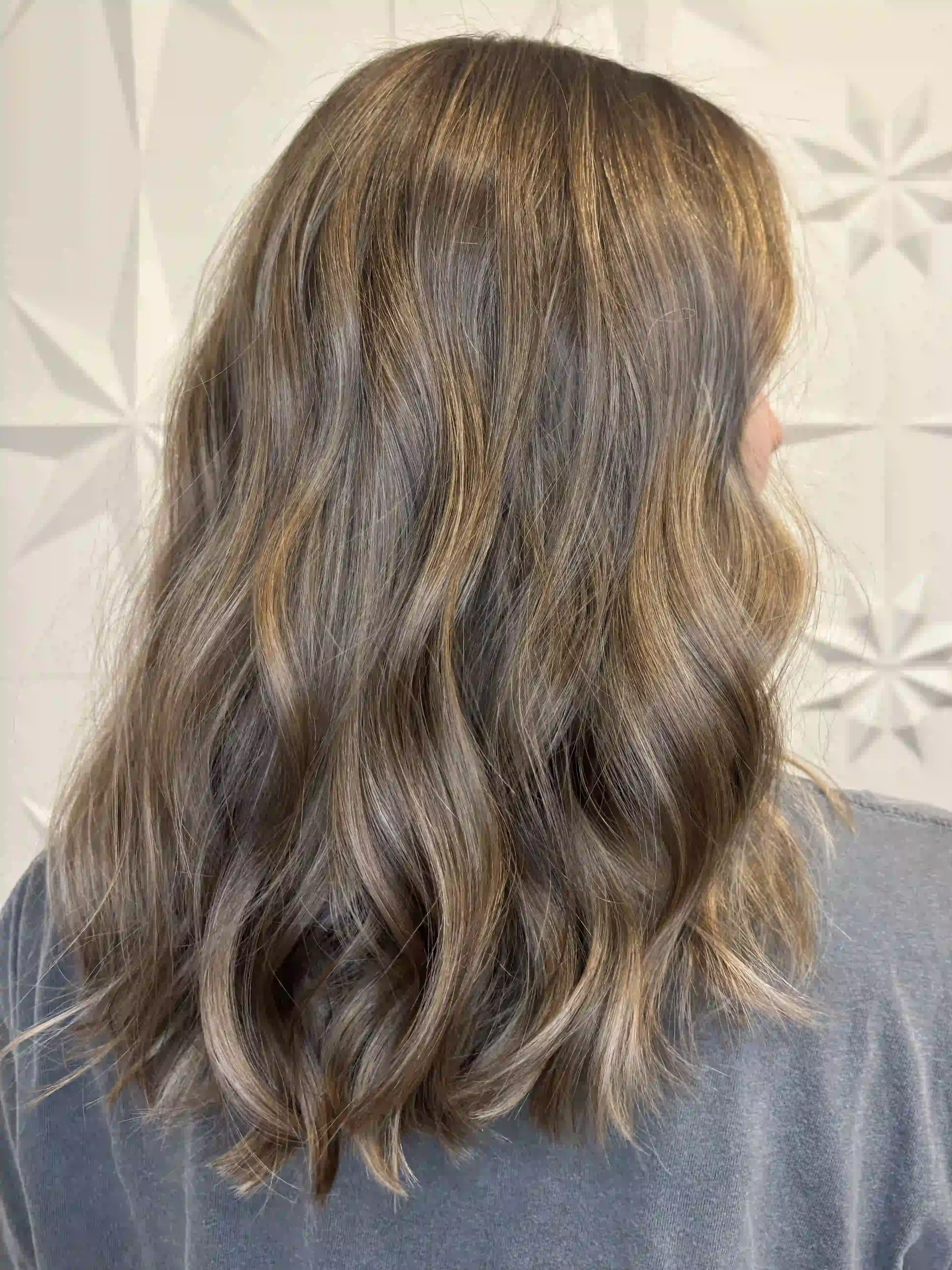 Lived-in bronde balayage with soft, natural waves and dimensional highlights, created by Alpin at Chroma Salon Queen Anne Seattle for a low-maintenance, sun-kissed look.