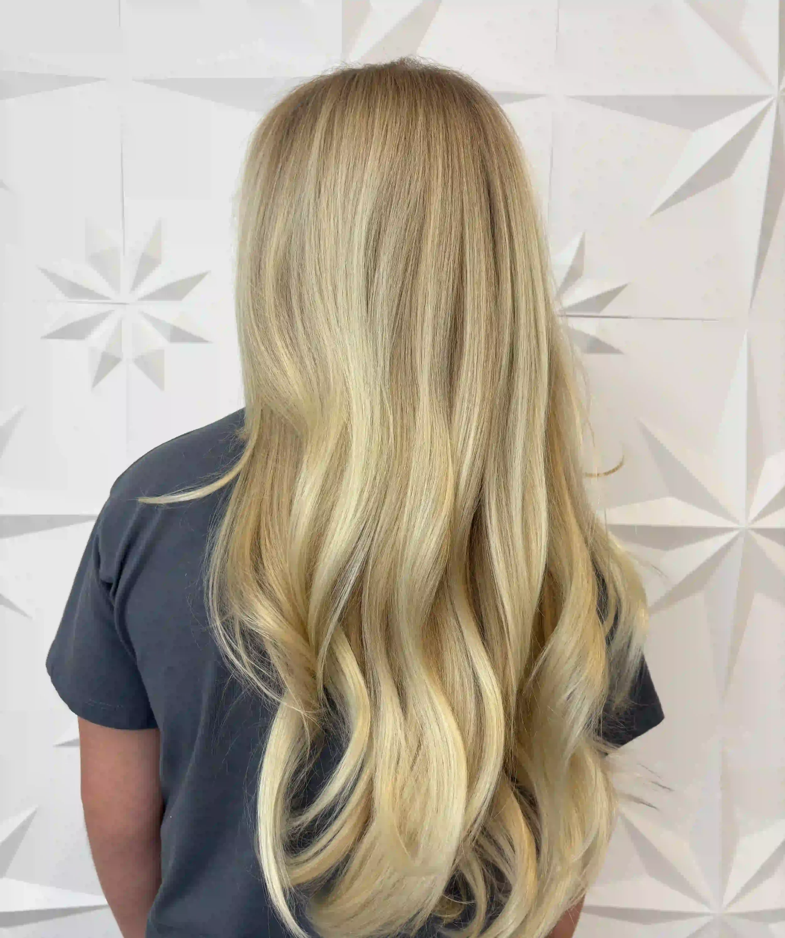 Long blonde balayage with soft, flowing waves and dimensional highlights, styled by Alpin at Chroma Salon Seattle.
