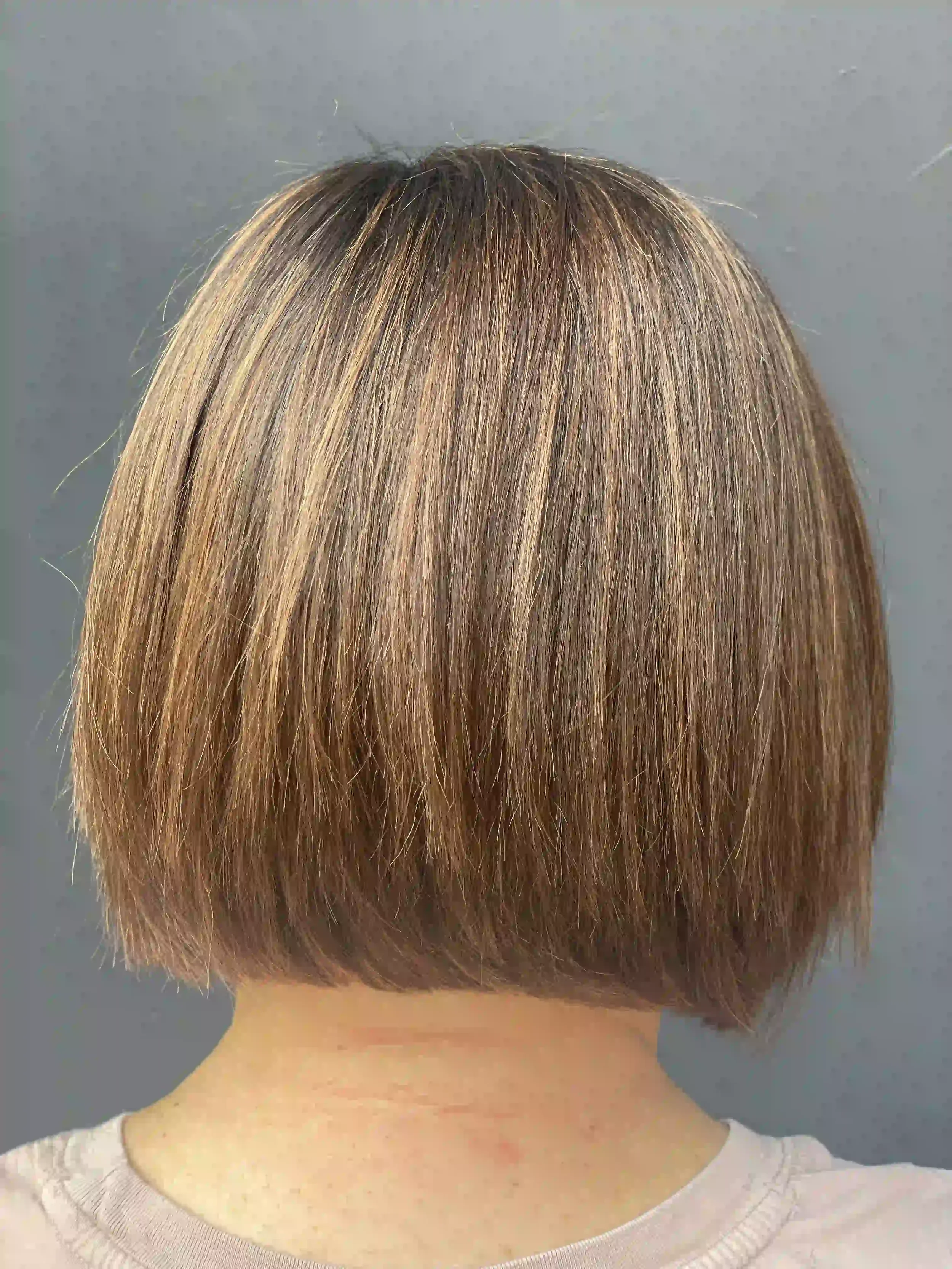 Textured brunette bob haircut with soft dimensional highlights and a blunt finish, styled by Anna at Chroma Salon Wallingford Seattle.