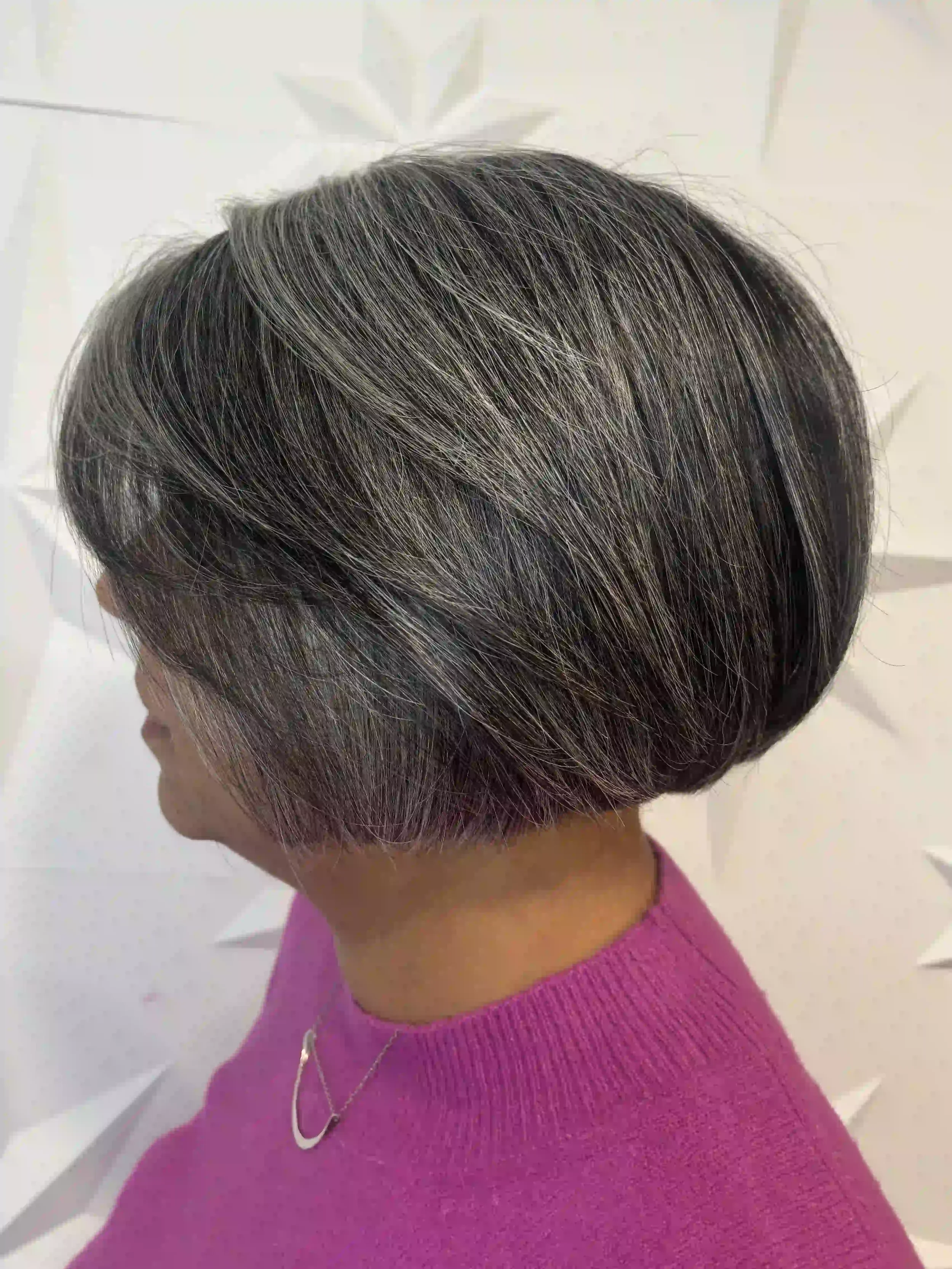 Stacked gray bob with soft layers and a rounded shape for added volume, styled by Alpin at Chroma Salon Queen Anne Seattle for a clean, modern finish.