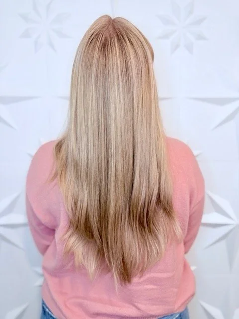 Soft beige blonde hair with long layers and a smooth, blended finish, created by Stormi at Chroma Salon Queen Anne Seattle for bright, natural-looking dimension.