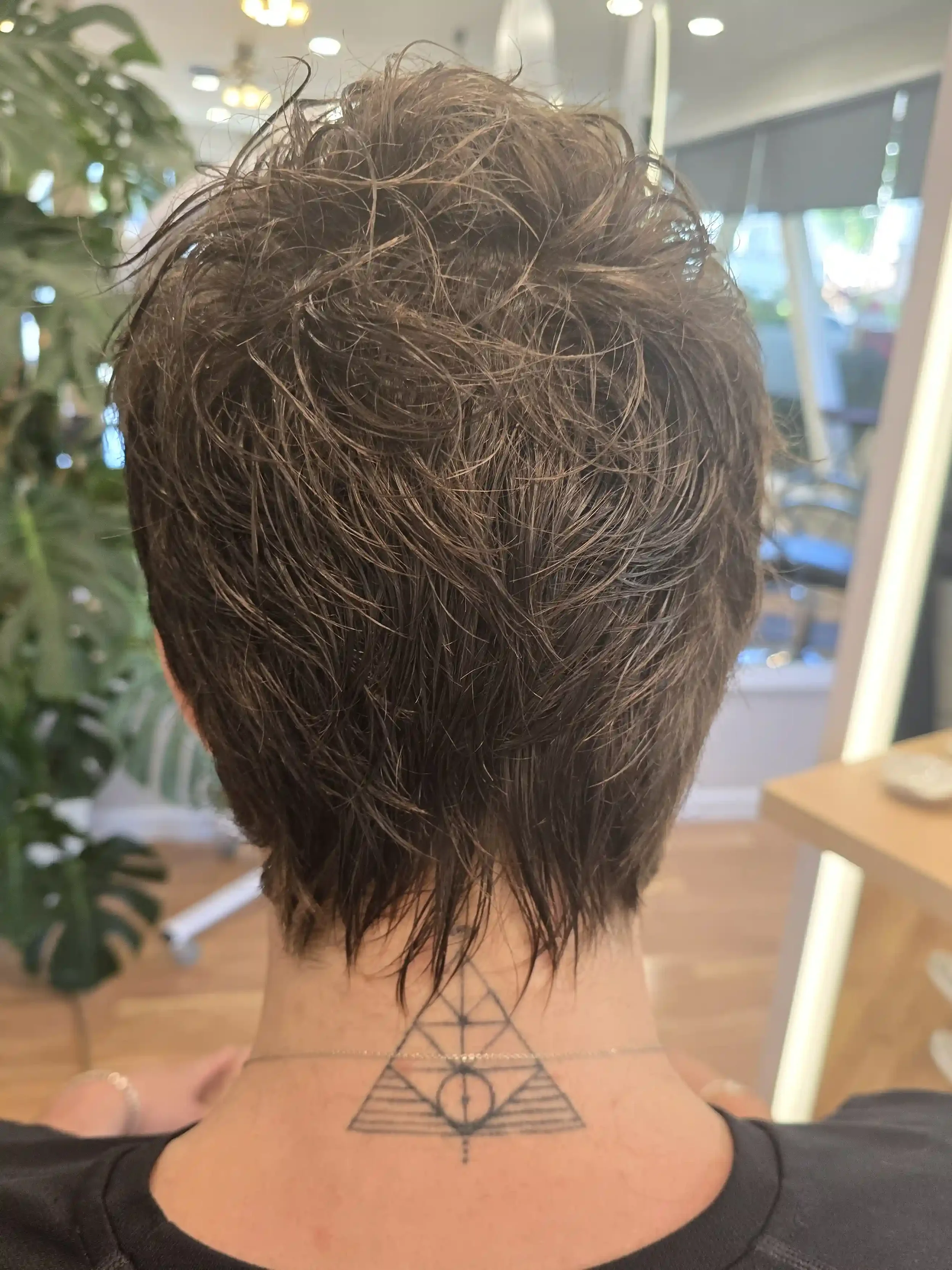 Short textured men’s haircut with soft layering, tapered nape detailing, and natural movement throughout the crown. Styled with a lived-in, piecey finish that enhances texture and volume while maintaining a clean silhouette. Cut by Jhana at Chroma Sa