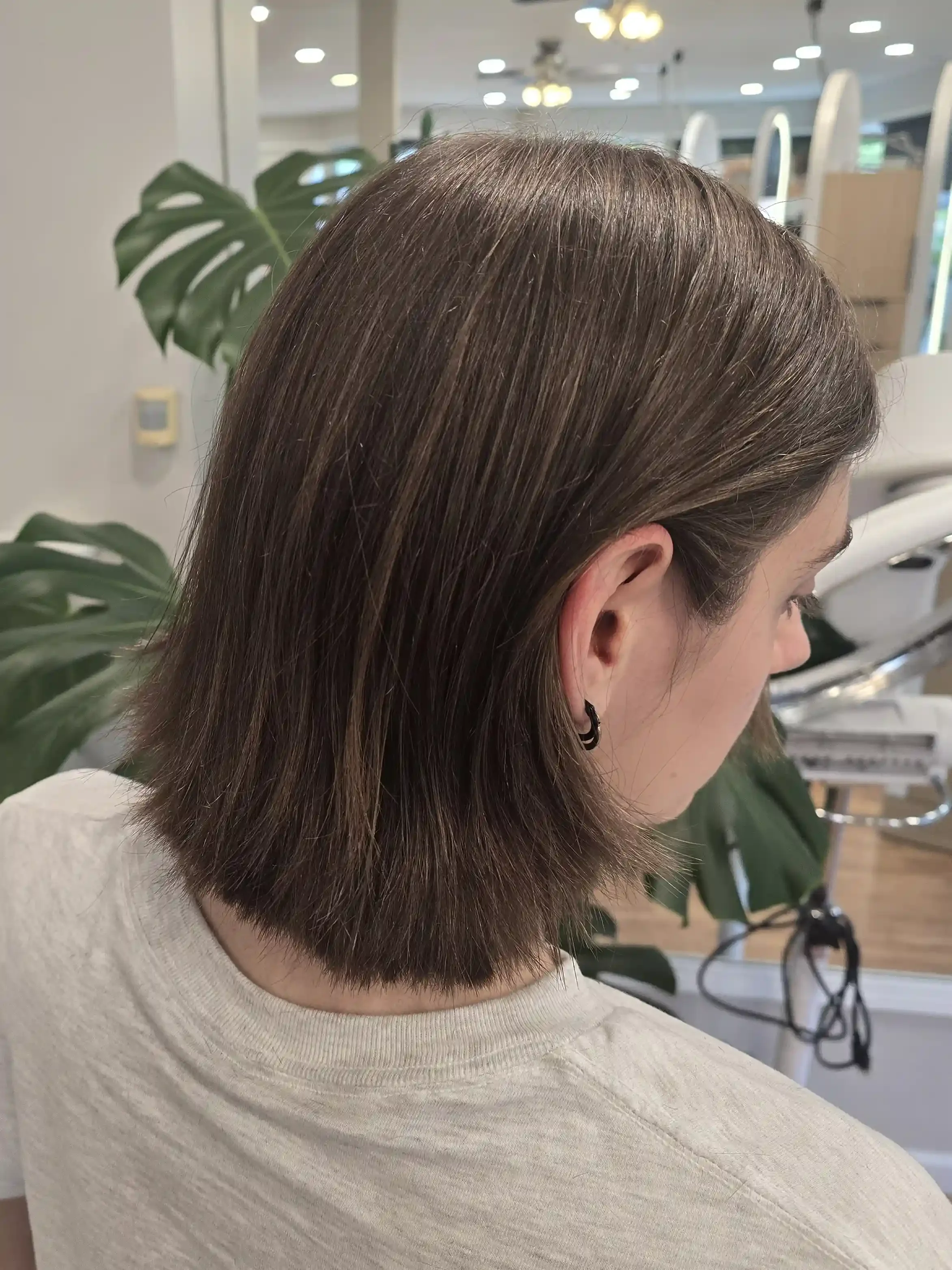 Classic brunette long bob (lob) featuring a rich, dimensional brunette tone and a clean, blunt perimeter with subtle internal layering for movement. The polished finish creates shine and fullness while maintaining a timeless, versatile shape that can
