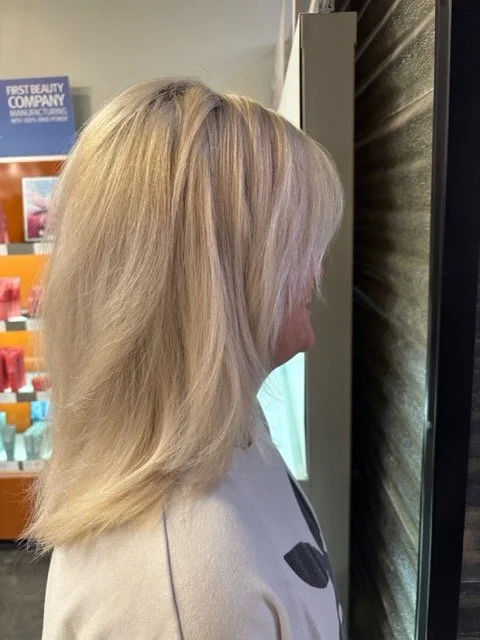 Soft layered blonde haircut with natural dimension and smooth finish, styled at Chroma Salon Seattle for healthy, bright blonding results.