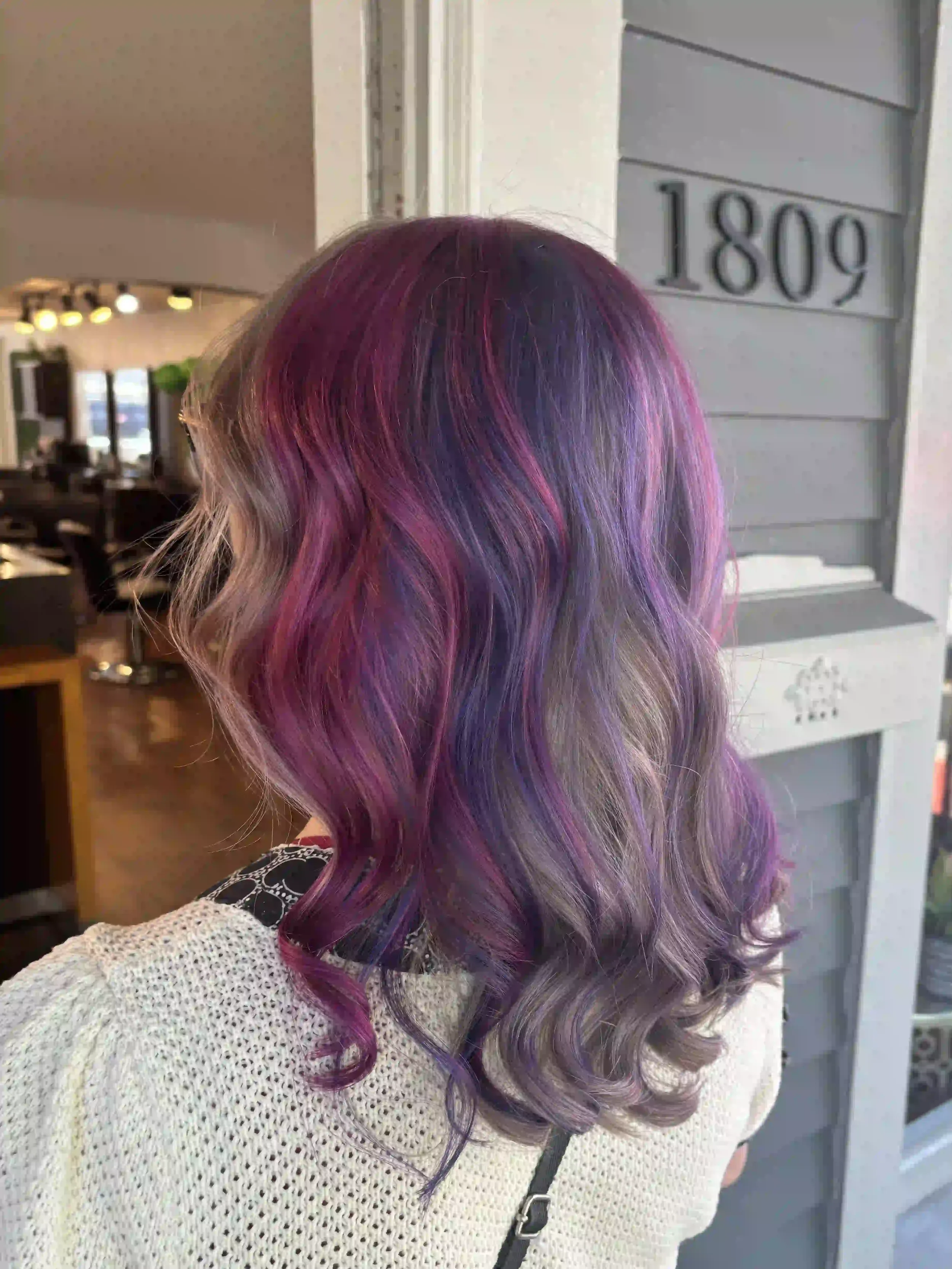 Purple and pink vivid balayage with soft waves and blended dimension, created by Alpin at Chroma Salon Seattle for bold, multi-tonal color.