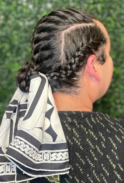 Back view of neatly braided hair styled into cornrows and tied with a patterned black-and-white scarf. Protective style created at a Seattle hair salon.