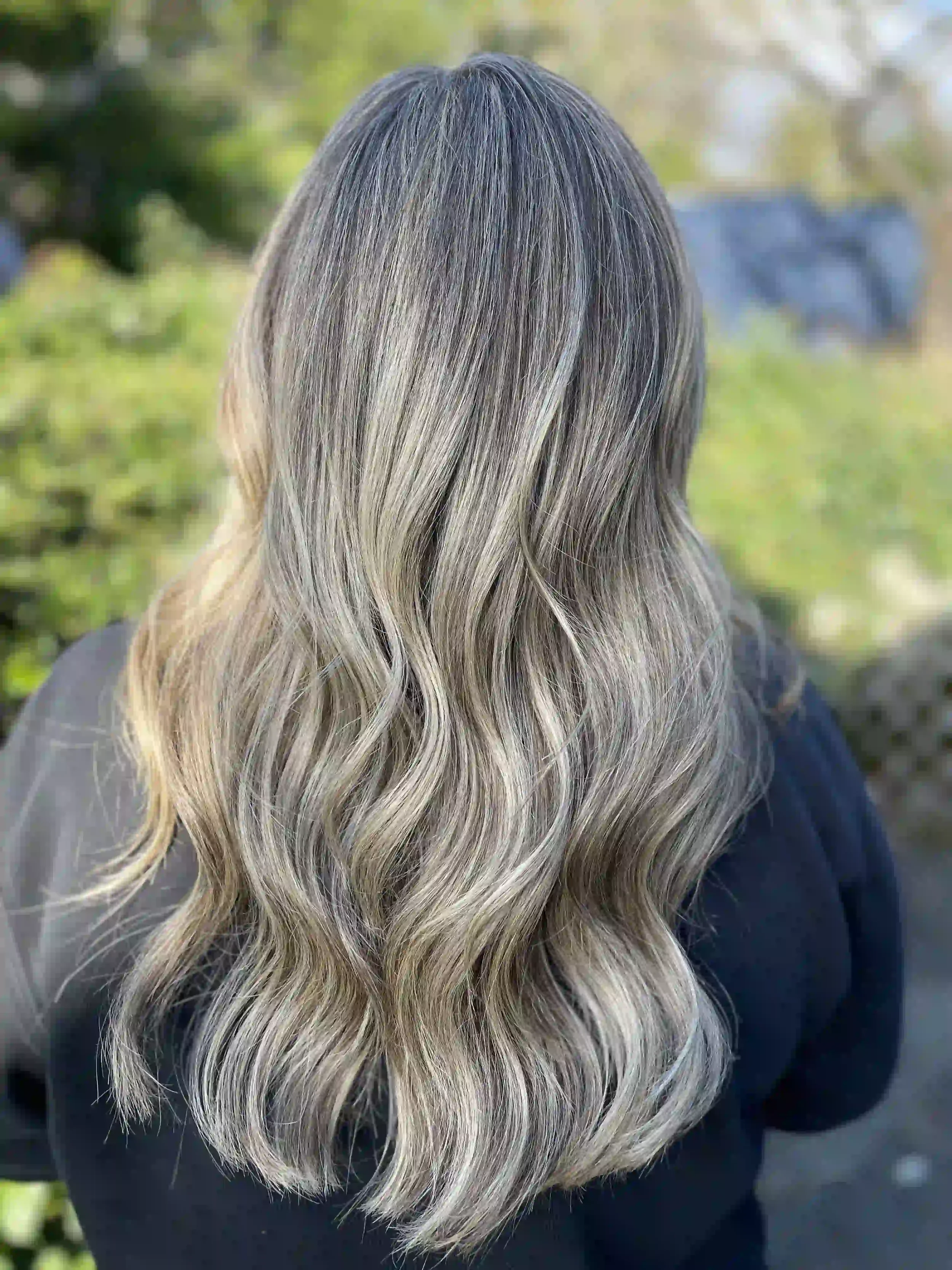 Cool mushroom blonde balayage with soft dimensional waves and blended shadow root, styled by Anna at Chroma Salon Wallingford Seattle.