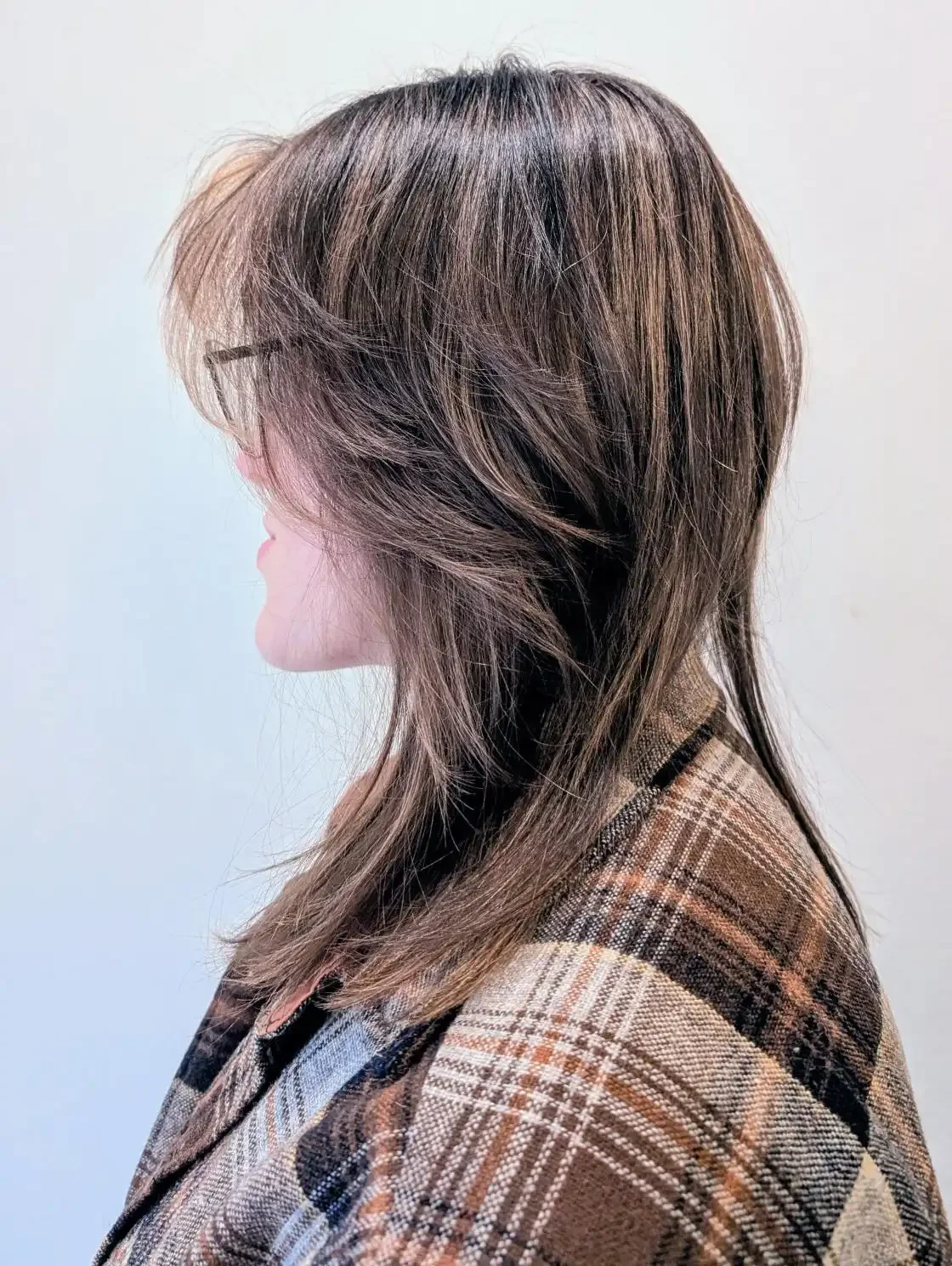 Layered brunette shag haircut with feathered texture and soft face-framing layers, styled by Christina at Chroma Salon Edmonds