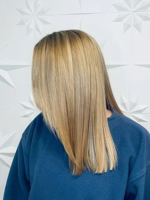 Bright blonde hair with seamless root blend and sleek, straight finish, created at Chroma Salon Seattle using professional Aveda blonding services.