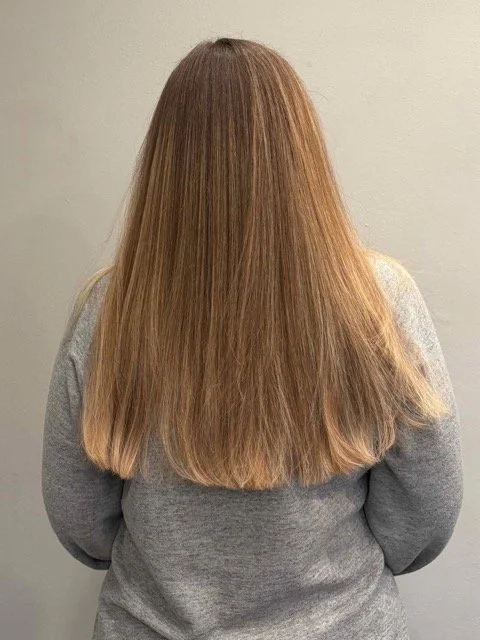 Straight, long brunette hair with soft natural highlights and a clean, blunt finish, showcasing a professional haircut and smoothing service at Chroma Salon in Lynnwood