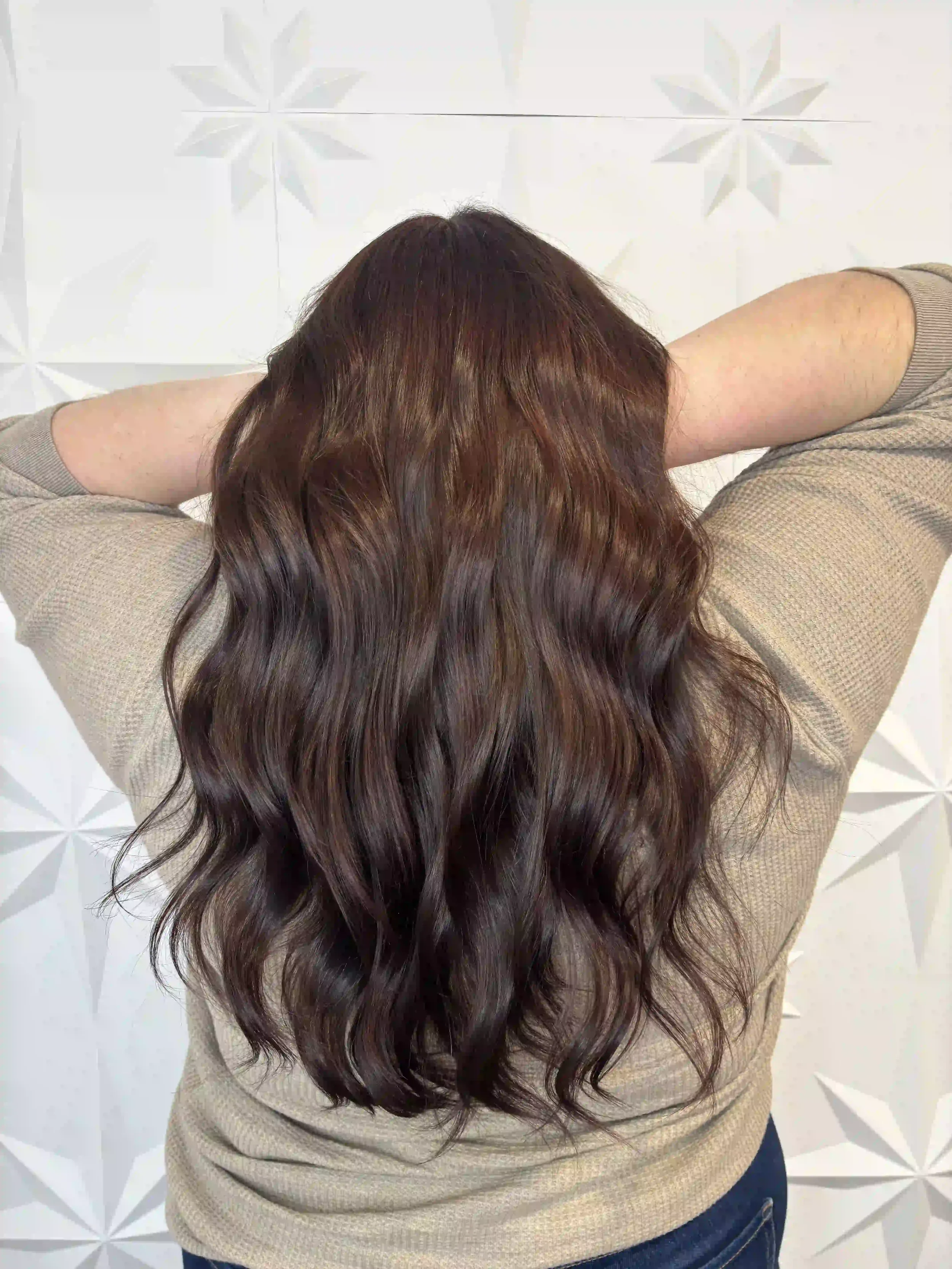 Rich brunette hair with dimensional warm brown tones and soft beachy waves, styled by Alpin at Chroma Salon Queen Anne Seattle.