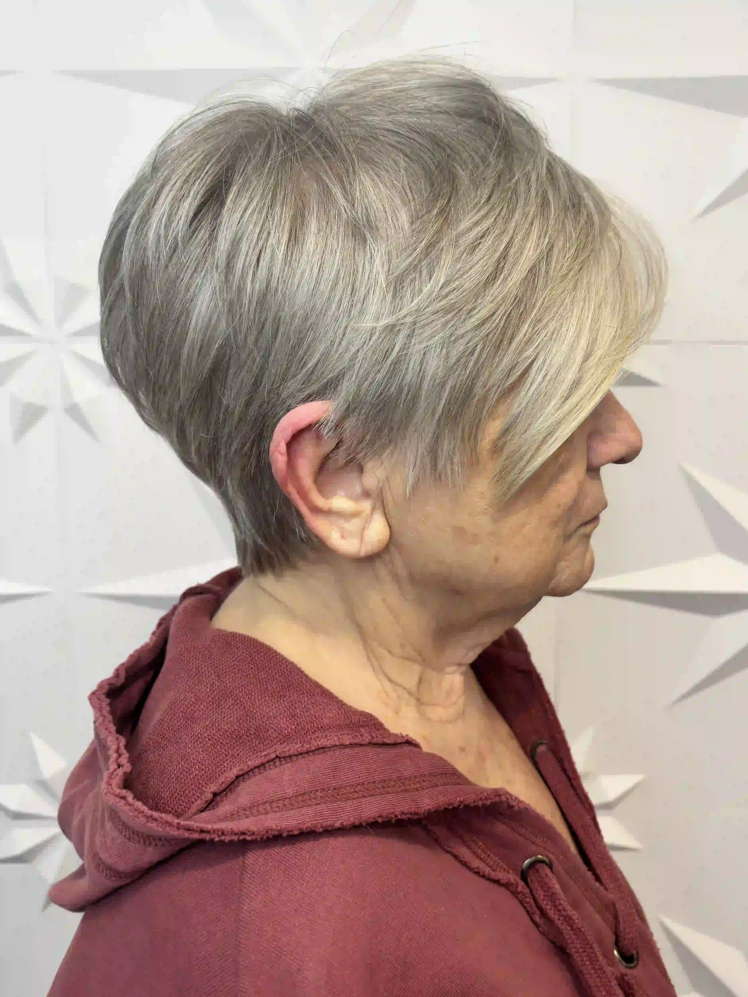 Short silver pixie cut with soft, textured layers and side-swept fringe, styled by Alpin at Chroma Salon Queen Anne Seattle for a modern, low-maintenance look.