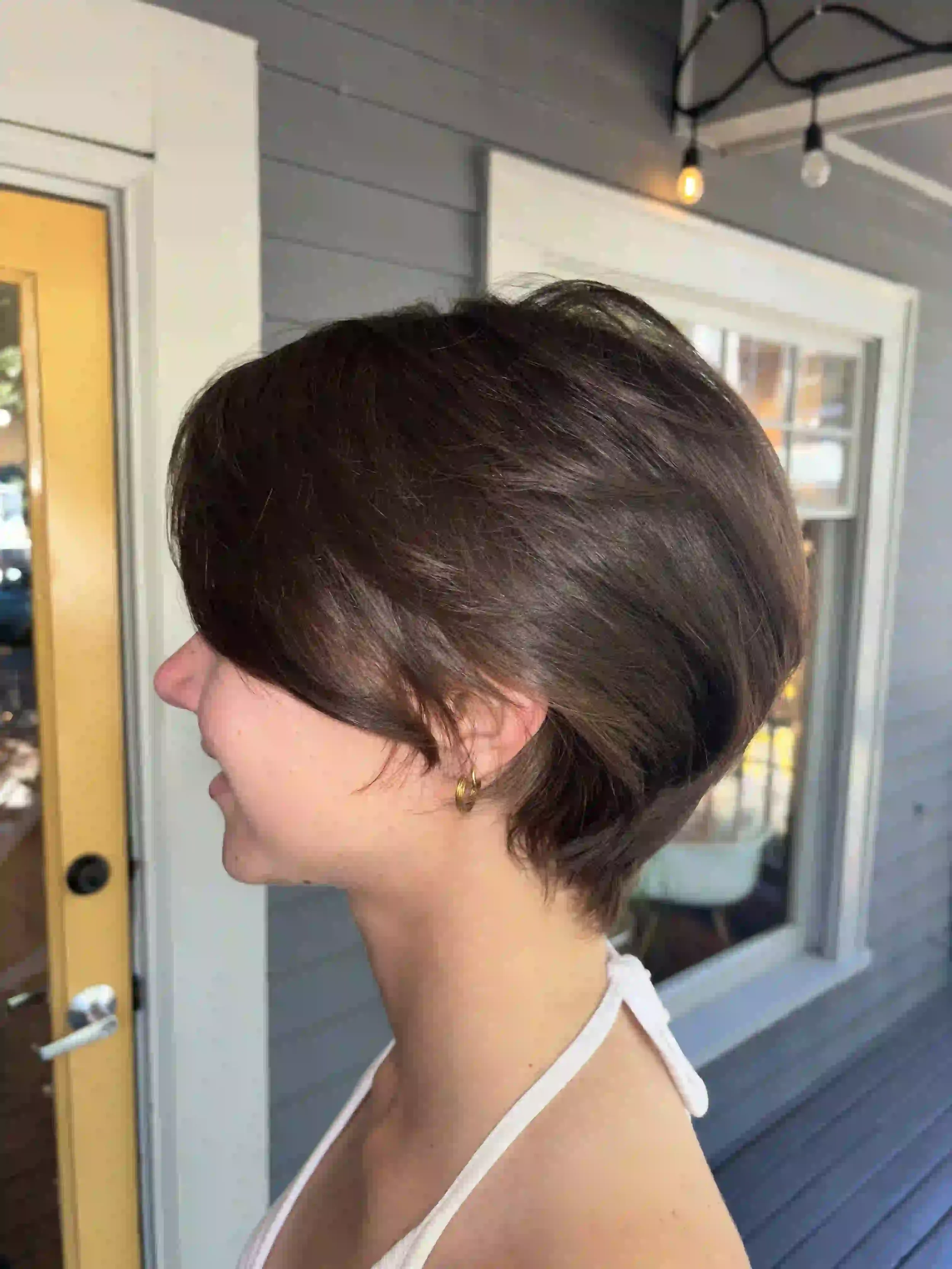 Short textured brown pixie bob with soft layering and natural movement, styled by Alpin at Chroma Salon Queen Anne Seattle.
