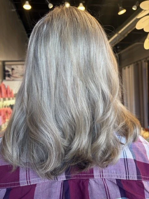 Cool-toned blonde balayage with soft waves and seamless root blend, created at Chroma Salon Seattle for a bright, dimensional finish.