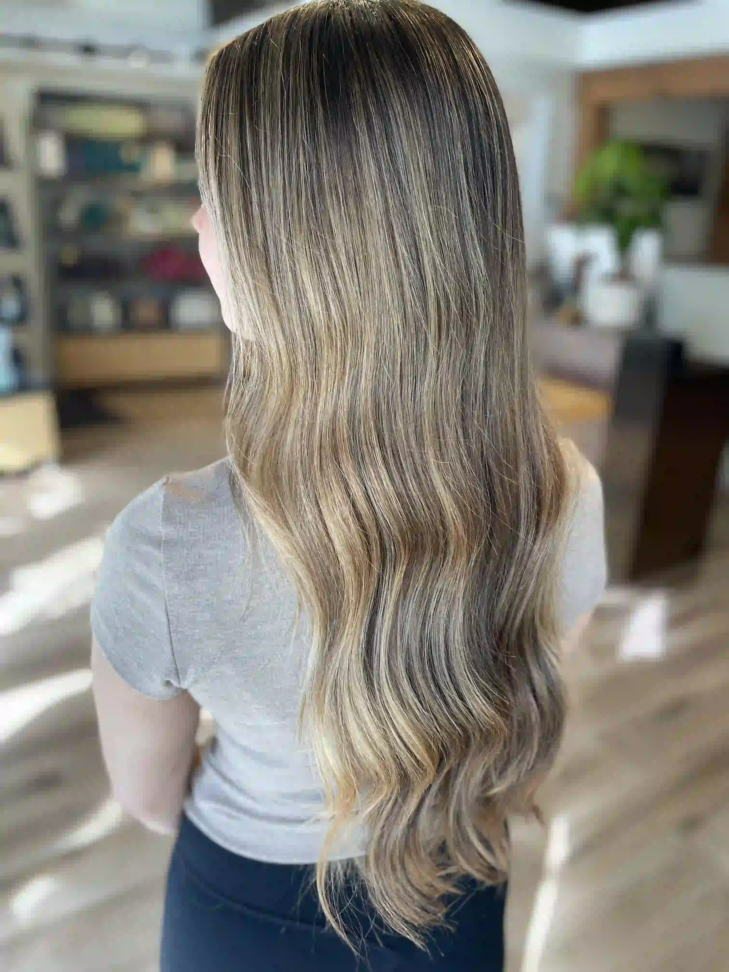 Lived-in beige bronde hair with soft dimensional highlights, long layers, and loose natural waves, styled by Anna at Chroma Salon Wallingford Seattle.