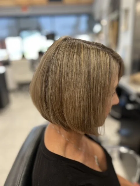Chin-length blonde bob with soft layers and natural highlights, styled at Chroma Salon Seattle for a polished, dimensional finish.