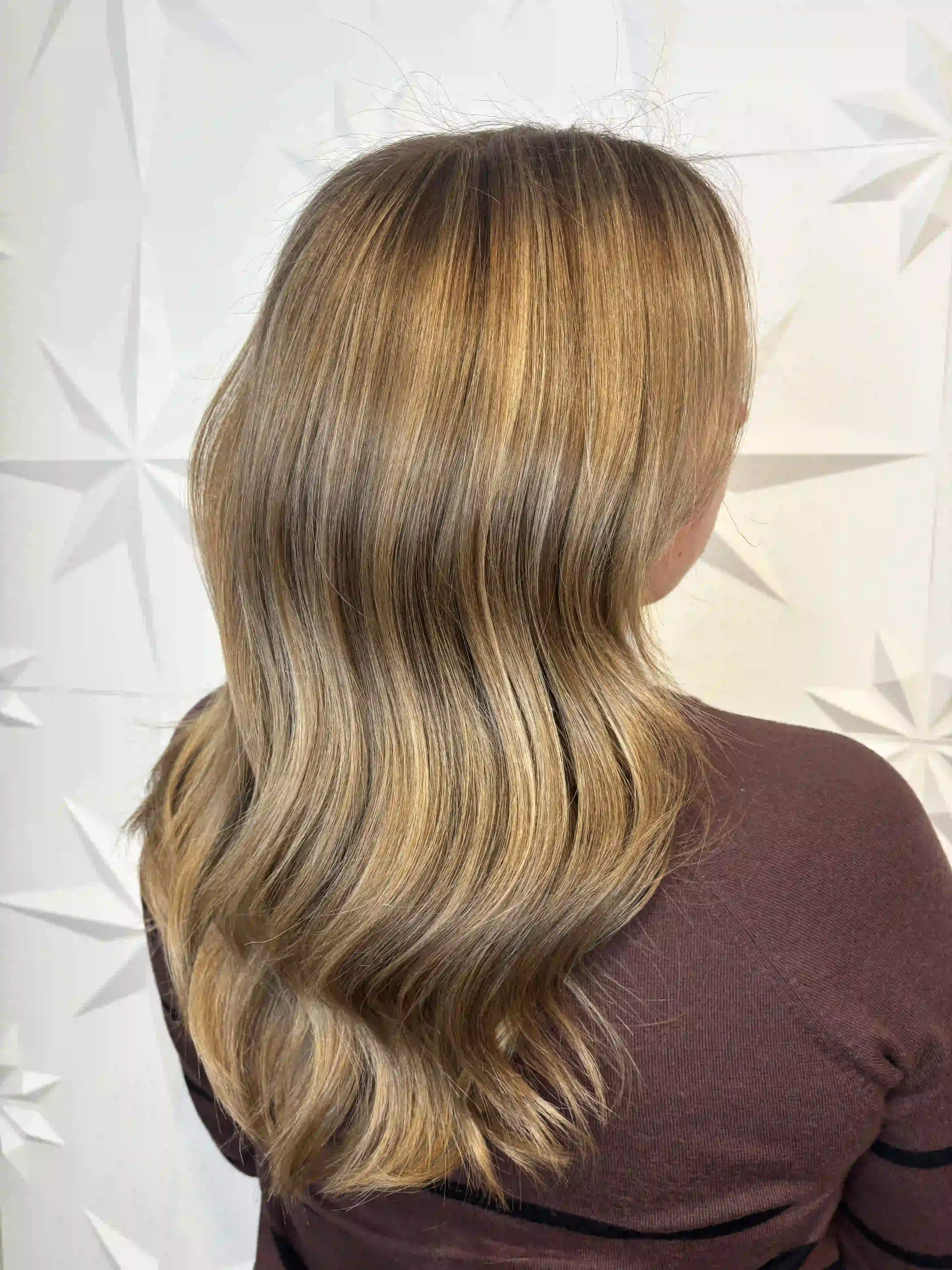 Soft bronde balayage on medium-length hair with loose, natural waves and blended dimension, created by Alpin at Chroma Salon Queen Anne Seattle.