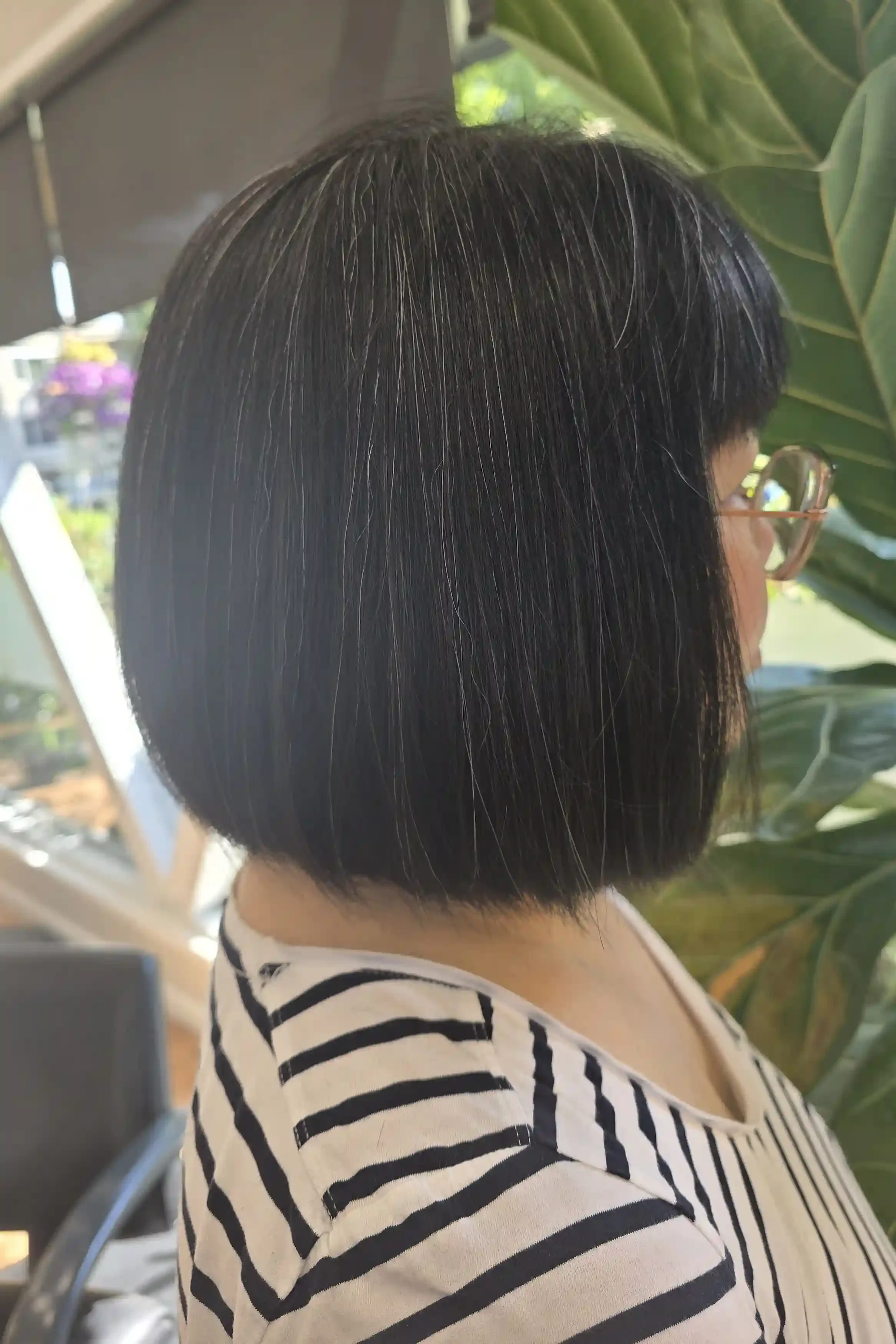 Precision chin-length black bob with a full fringe, featuring clean lines, sharp perimeter work, and a sleek, glossy finish. This classic bob haircut is tailored for a polished, timeless look that emphasizes shine, healthy hair, and effortless everyd