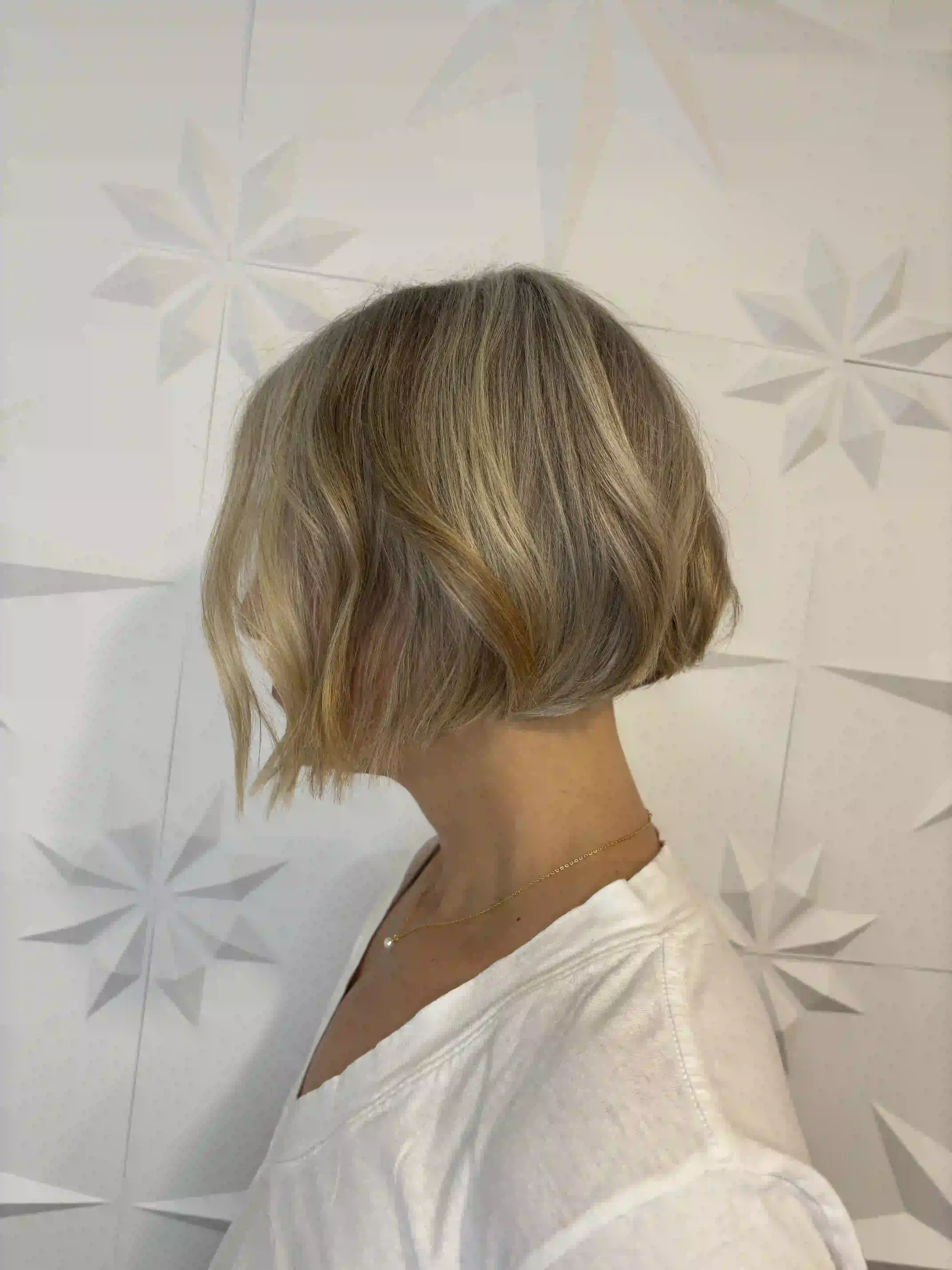 Textured blonde bob with soft waves, dimensional highlights, and a modern chin-length shape, styled by Alpin at Chroma Salon Queen Anne Seattle.