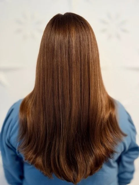 Glossy copper brunette hair with long layers and a smooth finish, created by Stormi at Chroma Salon Queen Anne Seattle for rich shine and dimension.