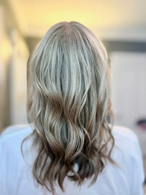 Cool-toned blonde balayage with soft waves and a natural root blend, created by Stormi at Chroma Salon Queen Anne Seattle for dimensional, low-maintenance color.