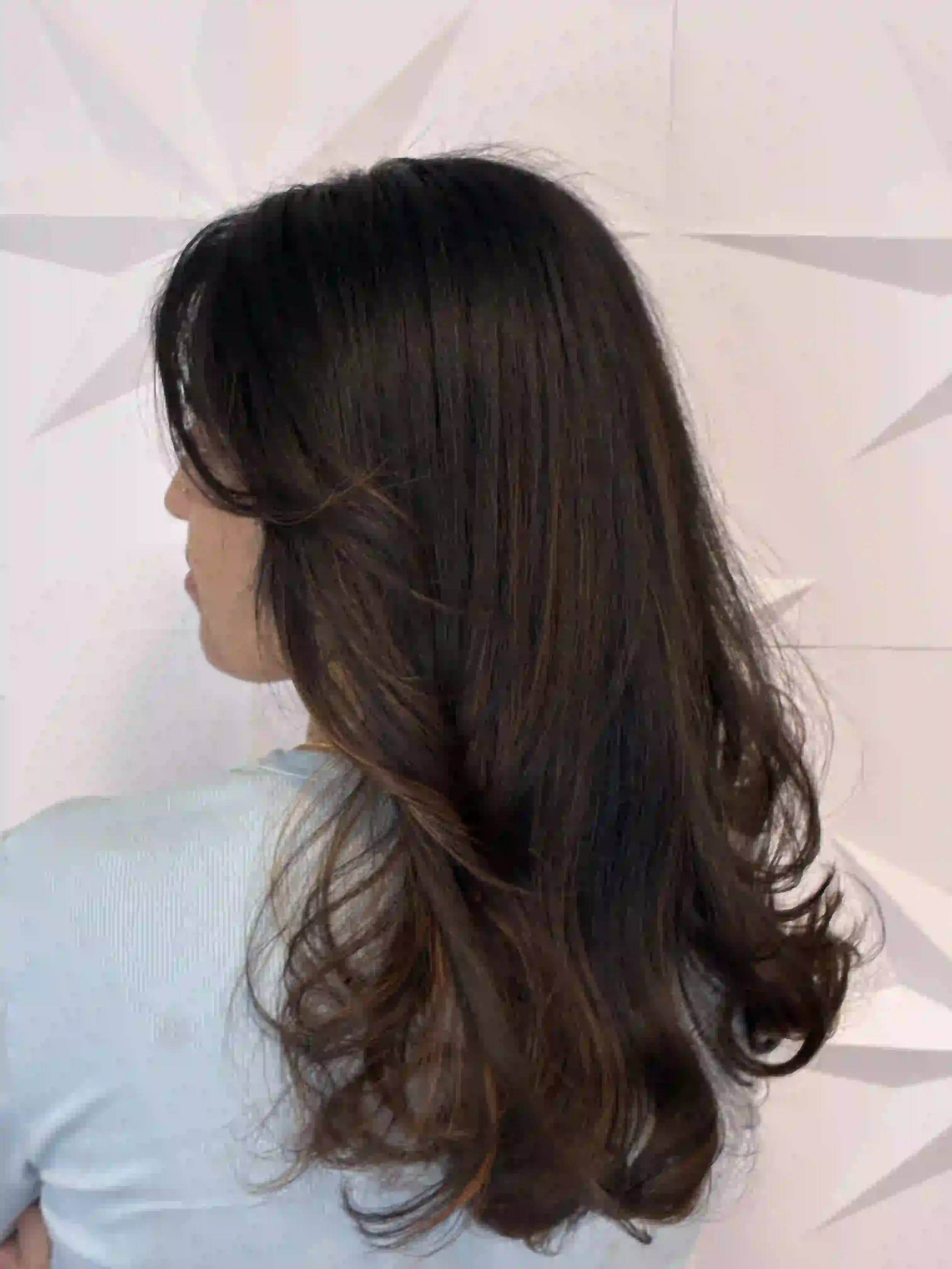 Long brunette hair with soft layers and loose waves, creating natural movement and shine, styled by Peter at Chroma Salon Seattle.