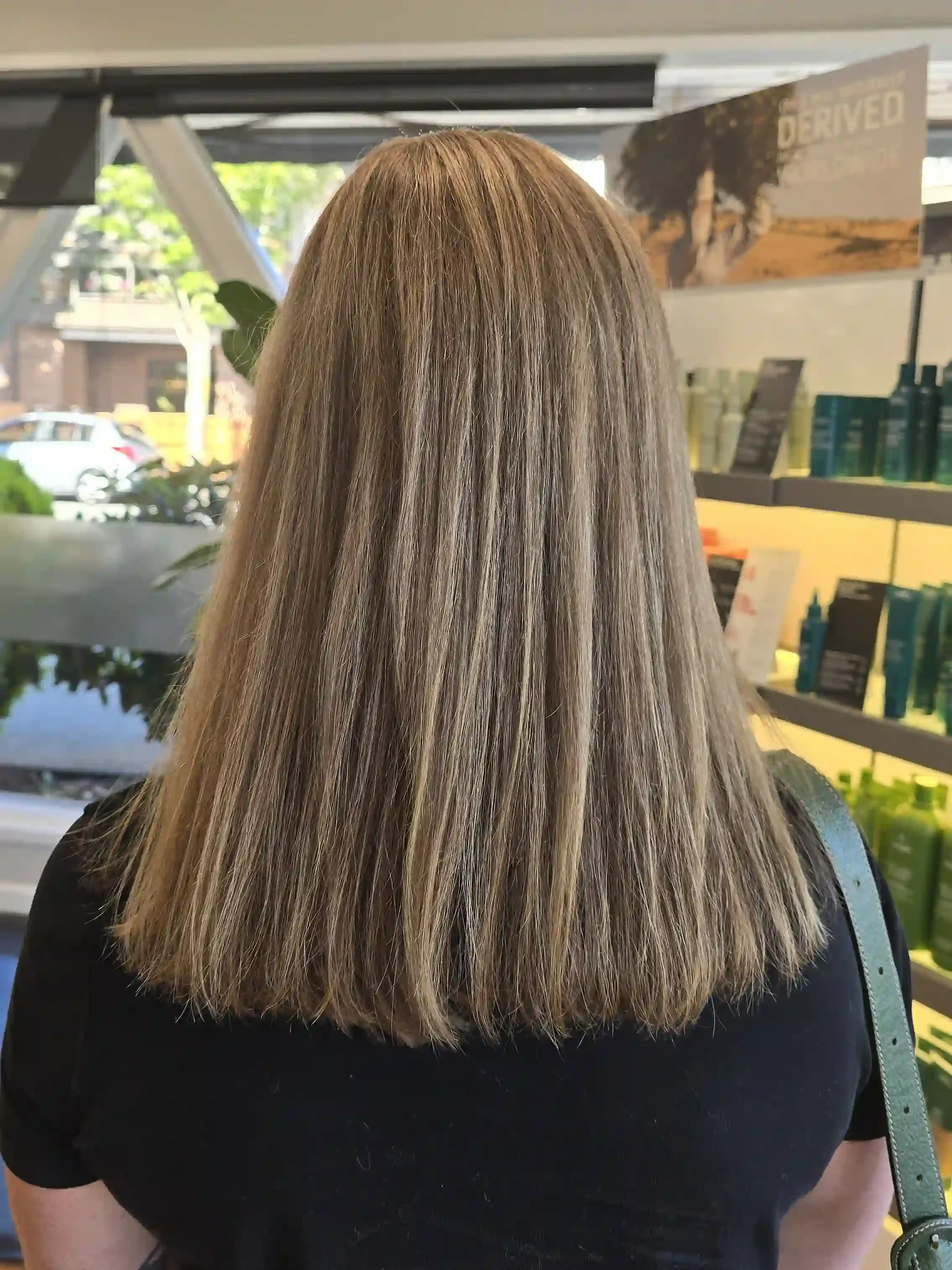Dimensional dark blonde hair with cool beige highlights, soft lowlights, and a precision blunt trim. This natural-looking blonde color enhances depth, shine, and dimension while maintaining a healthy, low-maintenance finish with smooth, polished styl