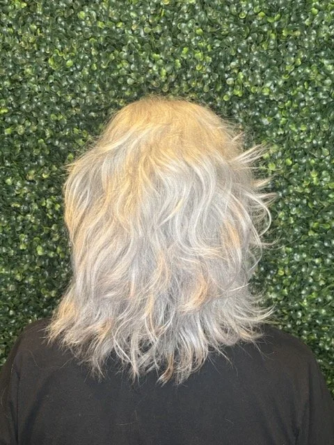 Soft layered shag hairstyle with natural texture and dimension, styled with Aveda products at Chroma Salon Seattle for a luminous gray finish.