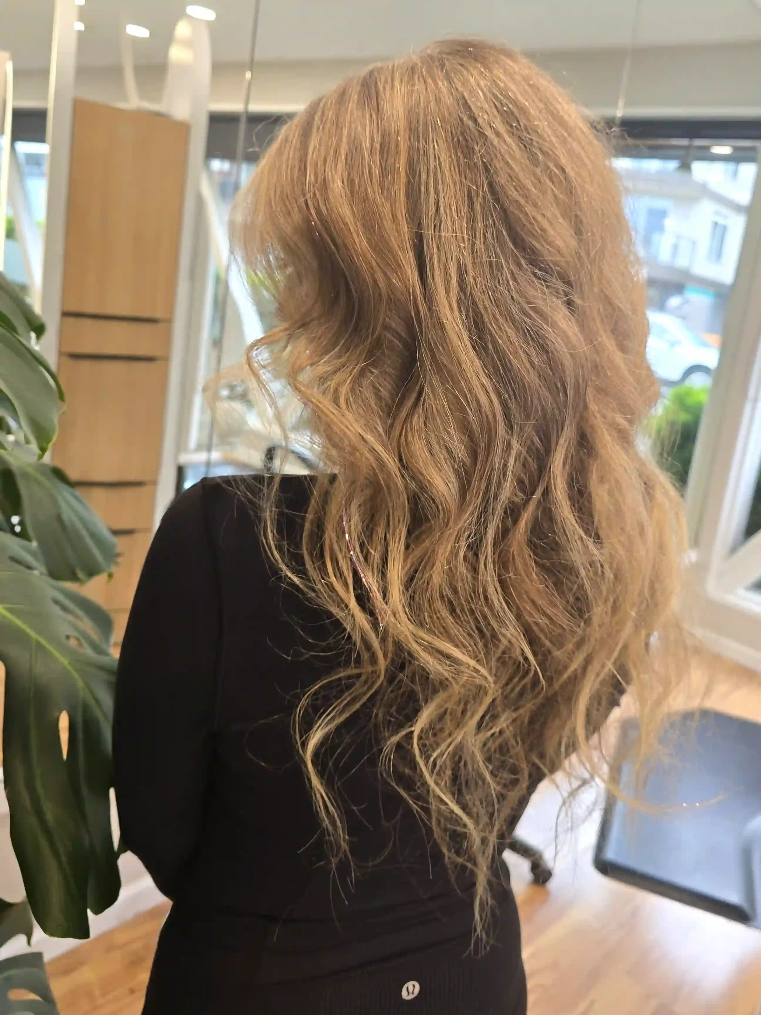 Long dimensional blonde balayage with soft lived-in highlights, a seamless root melt, face-framing brightness, and effortless beach waves. This low-maintenance blonde color creates natural depth, shine, and movement while maintaining a soft, blended 