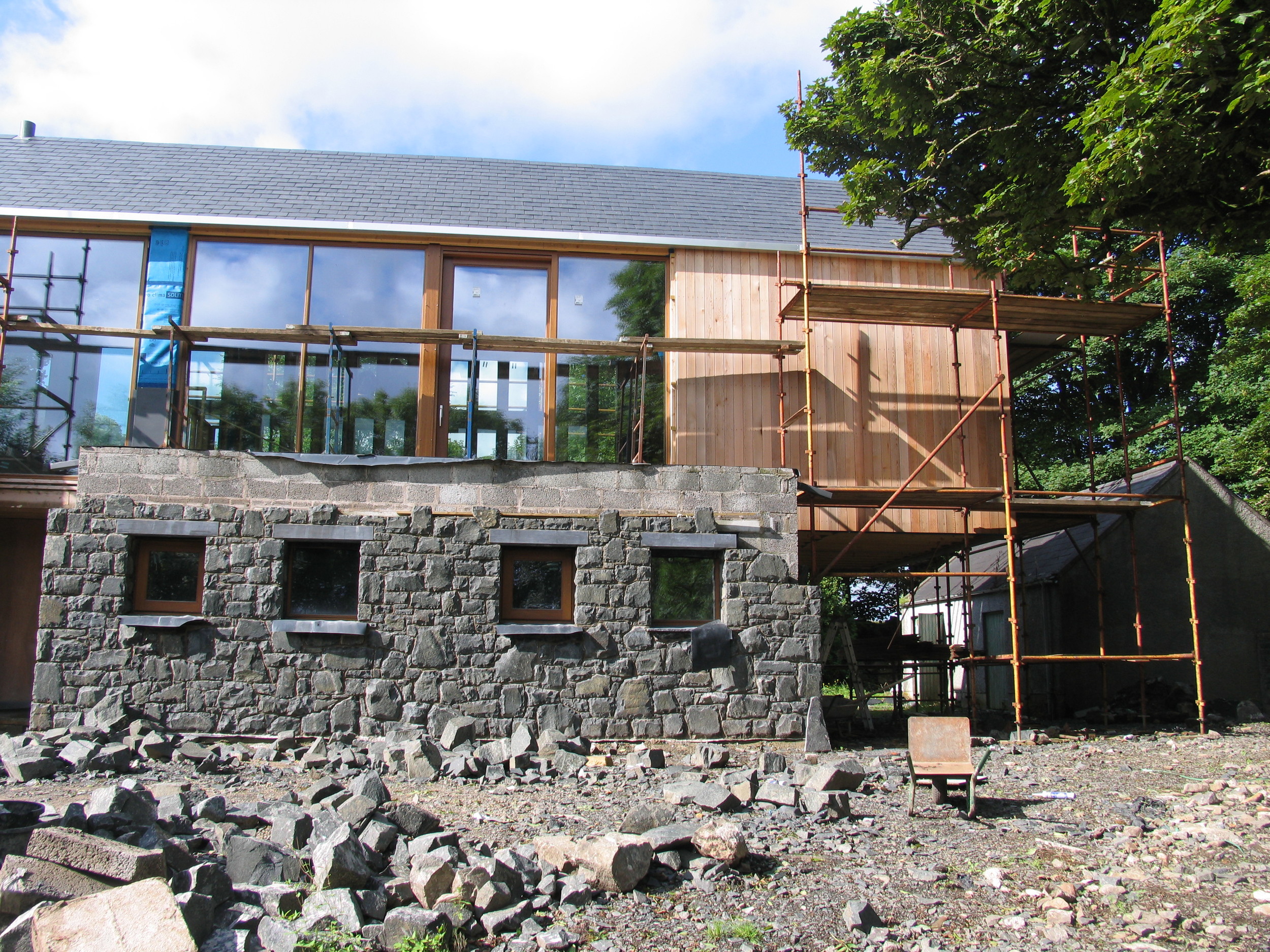 stone, windows, cedar cladding and cantilever
