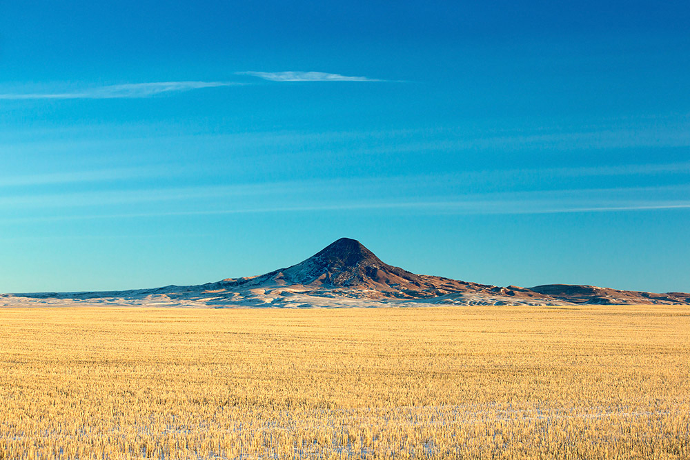 Gold Butte--part of the Sweet Grass Hills--rises from the middle of a wheat field north of Devon, Montana in Toole County.&nbsp;→ Buy This Print