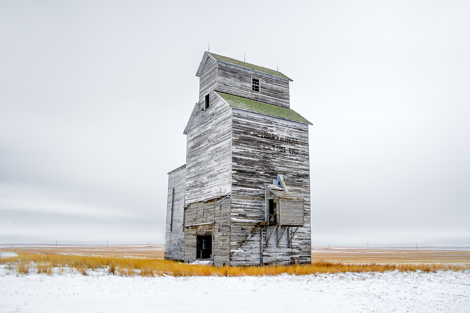 An old grain elevator stands watch over the cold, snow-covered Montana plains outside of the small town of Rudyard. It was -22 degrees Fahrenheit on the morning this photograph was taken. Just another day on the Hi-Line.&nbsp; &nbsp;→ Buy This Print
