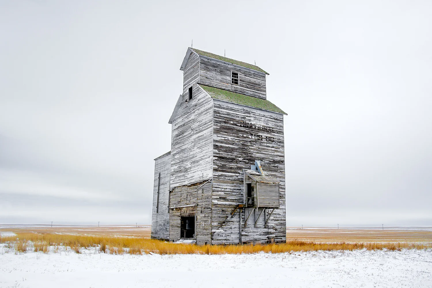 An old grain elevator stands watch over the cold, snow-covered Montana plains outside of the small town of Rudyard. It was -22 degrees Fahrenheit on the morning this photograph was taken. Just another day on the Hi-Line. → Buy This Print