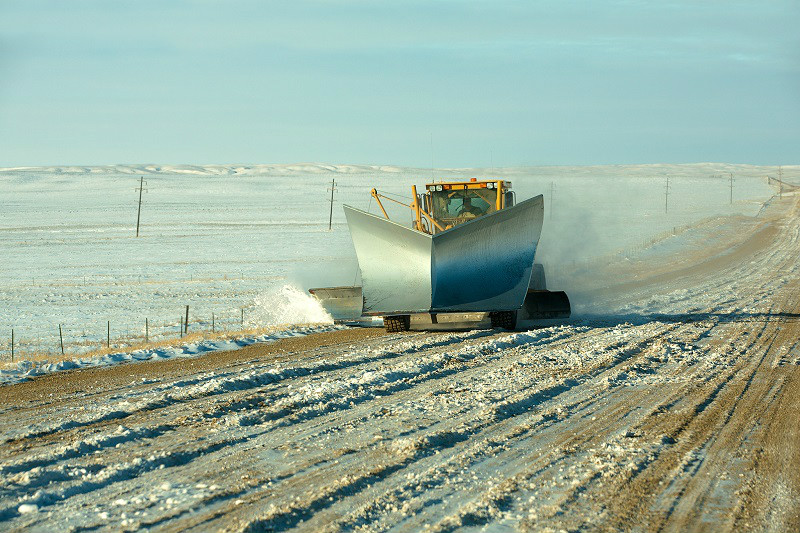A snow plow removes snow after the big storm from a rural gravel road in southern Chouteau County, Montana.&nbsp;→ License Photo.