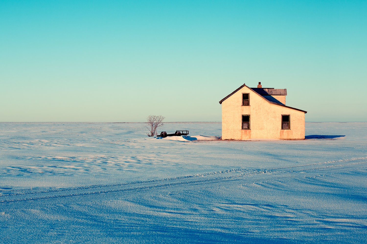 An old abandoned farm house surrounded by Montana's plains and snow north of Havre.&nbsp;→ Buy a Print