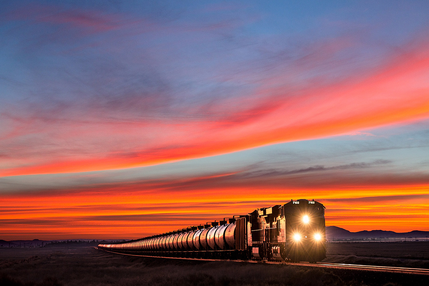 A BNSF train between Havre and Kremlin, Montana hauls oil from the Bakken oil fields west to be refined. → Buy a Print