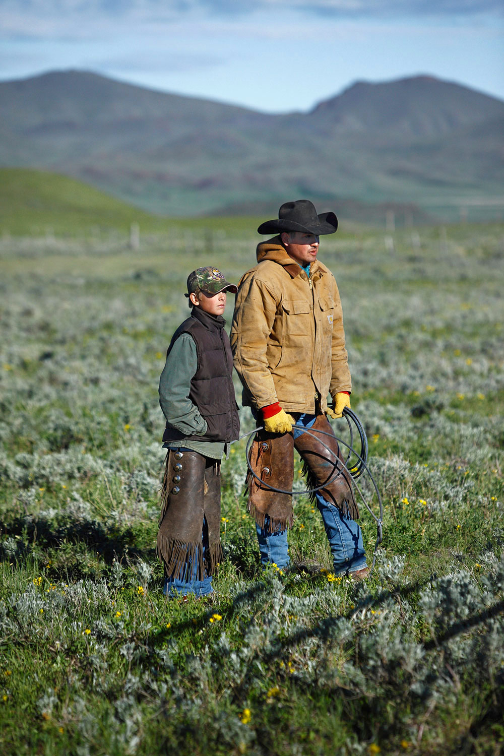 Garrison and his father preparing to round up cattle near Cleveland, Montana.