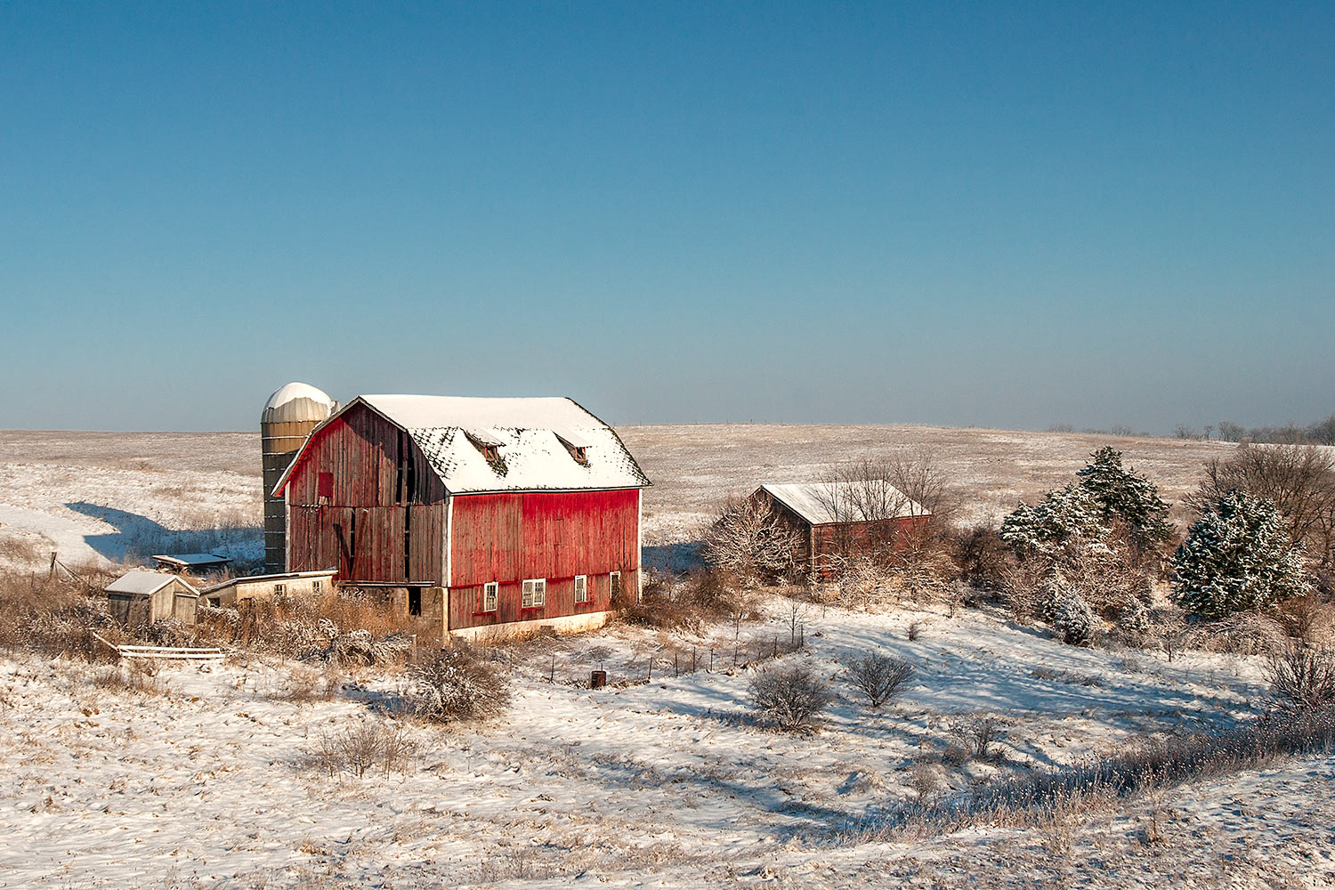 An old dairy farm no longer in use shrouded in snow near Blanchardville, Wisconsin.&nbsp;→ Buy a Print