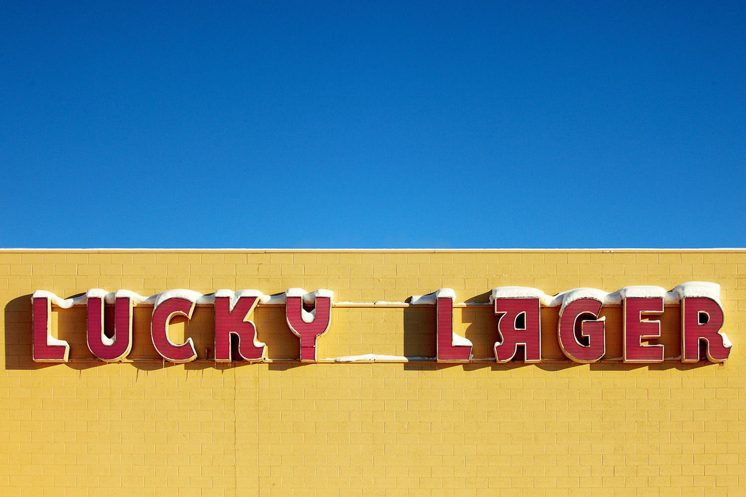 A Lucky Lager beer sign on the side of a building near downtown Havre, Montana.&nbsp;→ Buy a Print