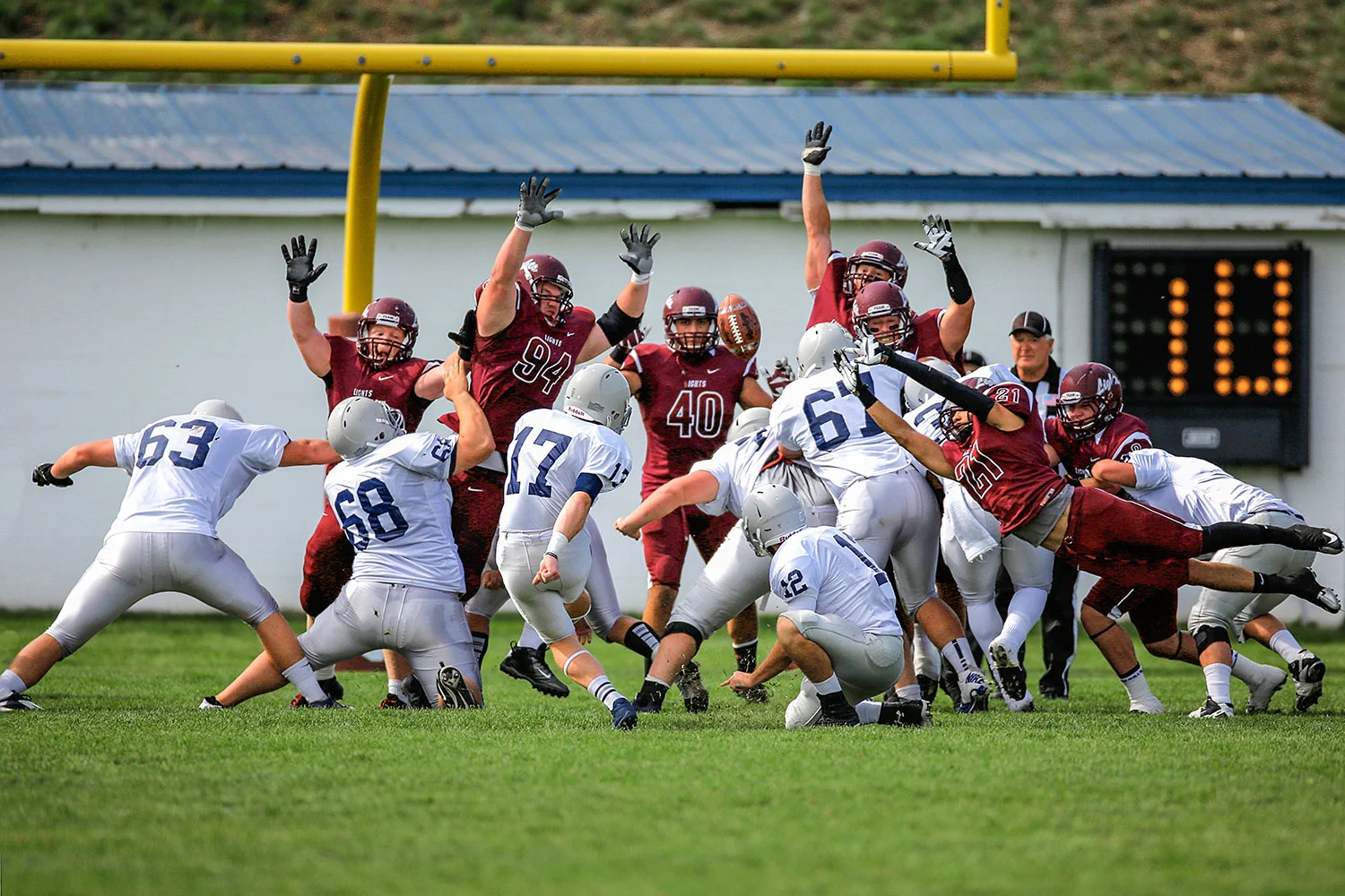Photograph of a kicker attempting a field goal at MSU-Northern collegiate football game in Havre, Montana.