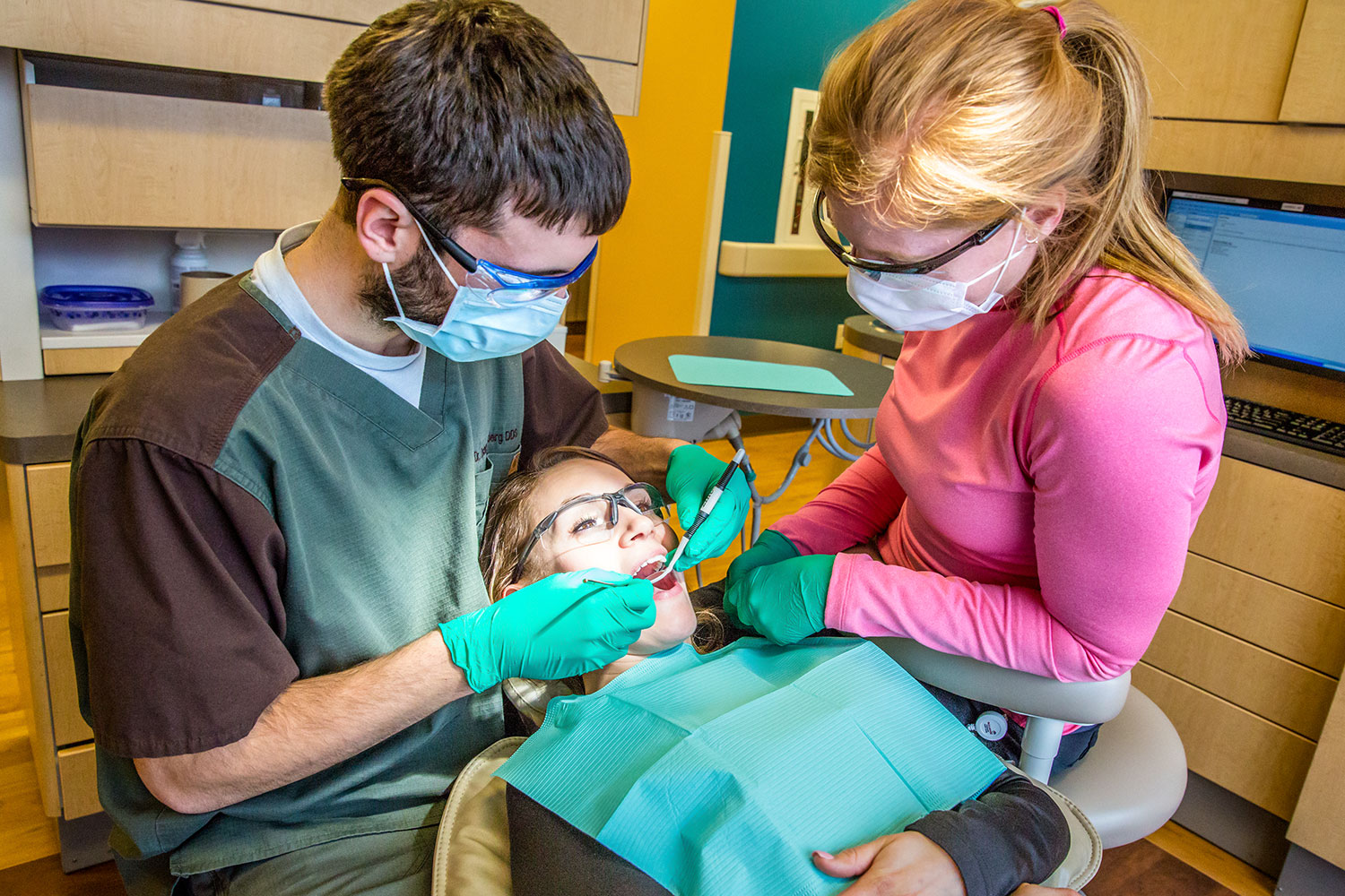 A photograph of a dentist working on patient at Bullhook Community Medical Center in Havre, Montana while on commercial assignment for the Montana Community Development Corporation.