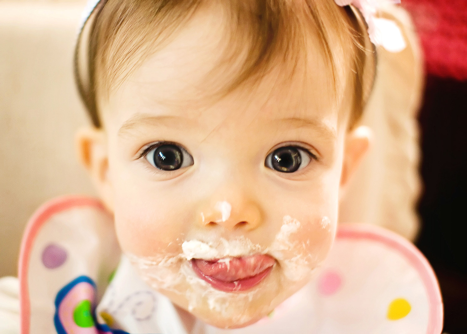 A photograph of my niece Amber enjoying a taste of cake at her first birthday party.