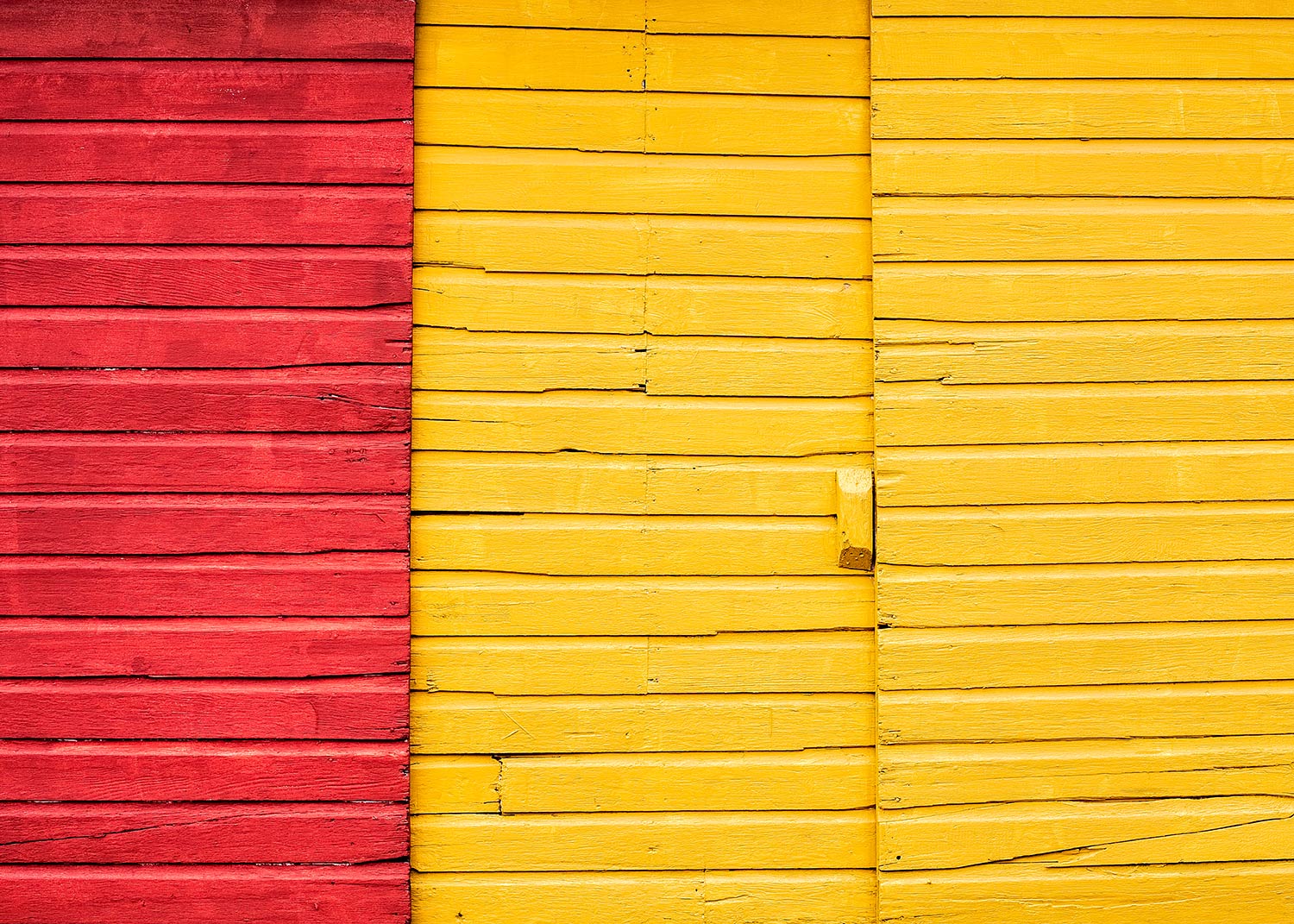 Rich, colorful sliding doors on the side of the New Glarus Lumber building in New Glarus, Wisconsin. → Buy a Print