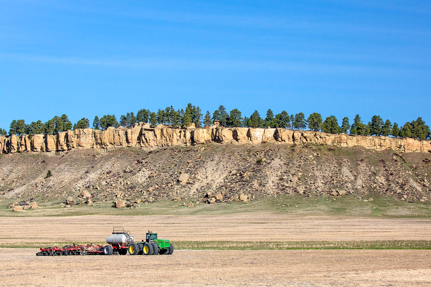 Farm equipment parked by the rimrocks near Ryegate, Montana.&nbsp;→ Buy a Print&nbsp;or License Photo